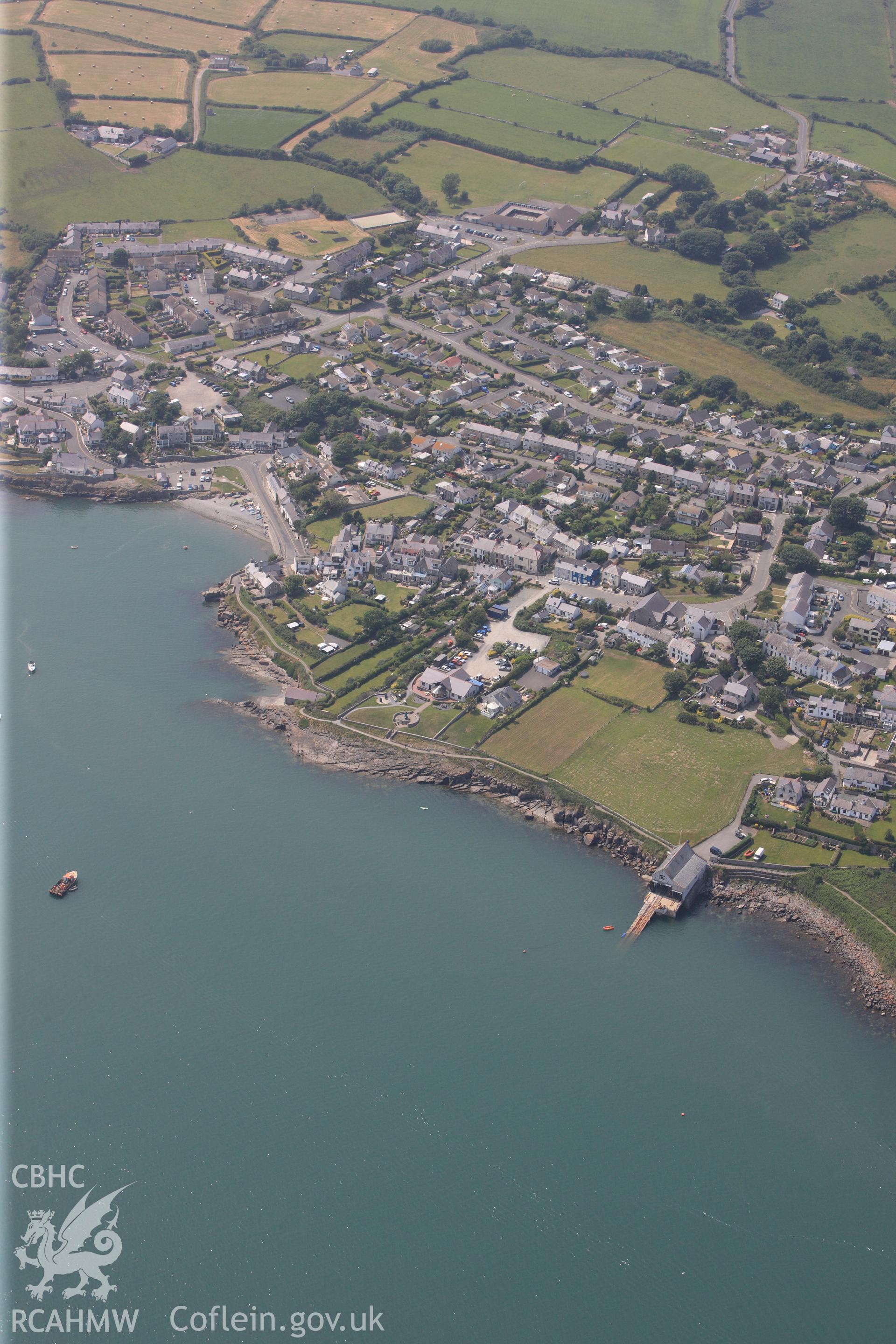 The town of Moelfre, including its lifeboat station, on the east coast of Anglesey. Oblique aerial photograph taken during the Royal Commission?s programme of archaeological aerial reconnaissance by Toby Driver on 12th July 2013.