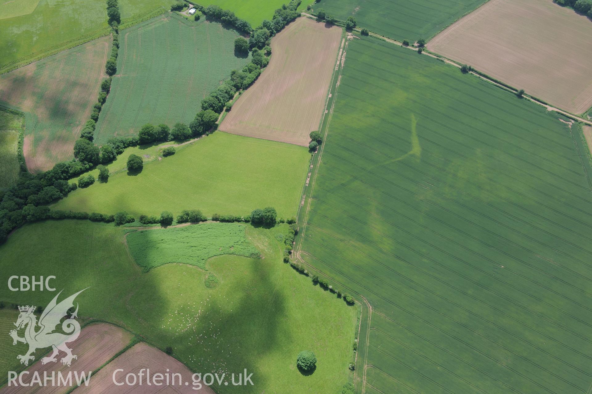 Ffynnon Gaer Hillfort and possible trackway measuring 200m running south west from the hillfort. Oblique aerial photograph taken during the Royal Commission's programme of archaeological aerial reconnaissance by Toby Driver on 29th June 2015.