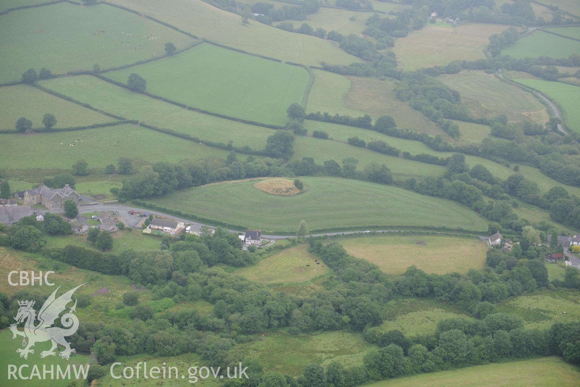 Castell Mawr motte and bailey and Maesgwynne Arms Hotel on the left edge of the photograph, to the south east of Llanboidy. Oblique aerial photograph taken during the Royal Commission?s programme of archaeological aerial reconnaissance by Toby Driver on 1st August 2013.