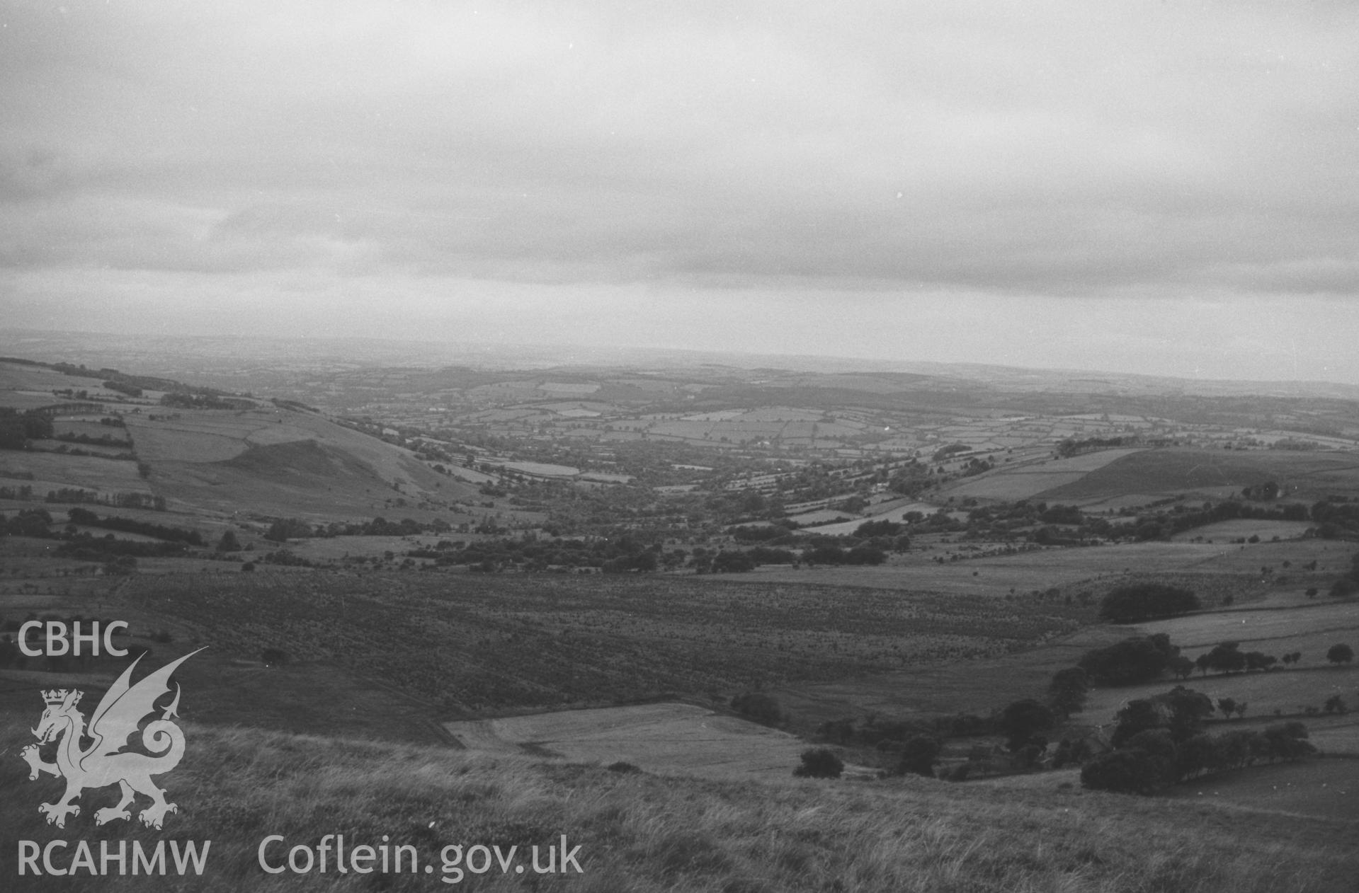 Digital copy of a black and white negative showing view down the Ffrwd Cynon valley from Esgair Fraith, east of Lampeter. Photographed by Arthur O. Chater in August 1965 from Grid Reference SN 6481 4823, looking west.