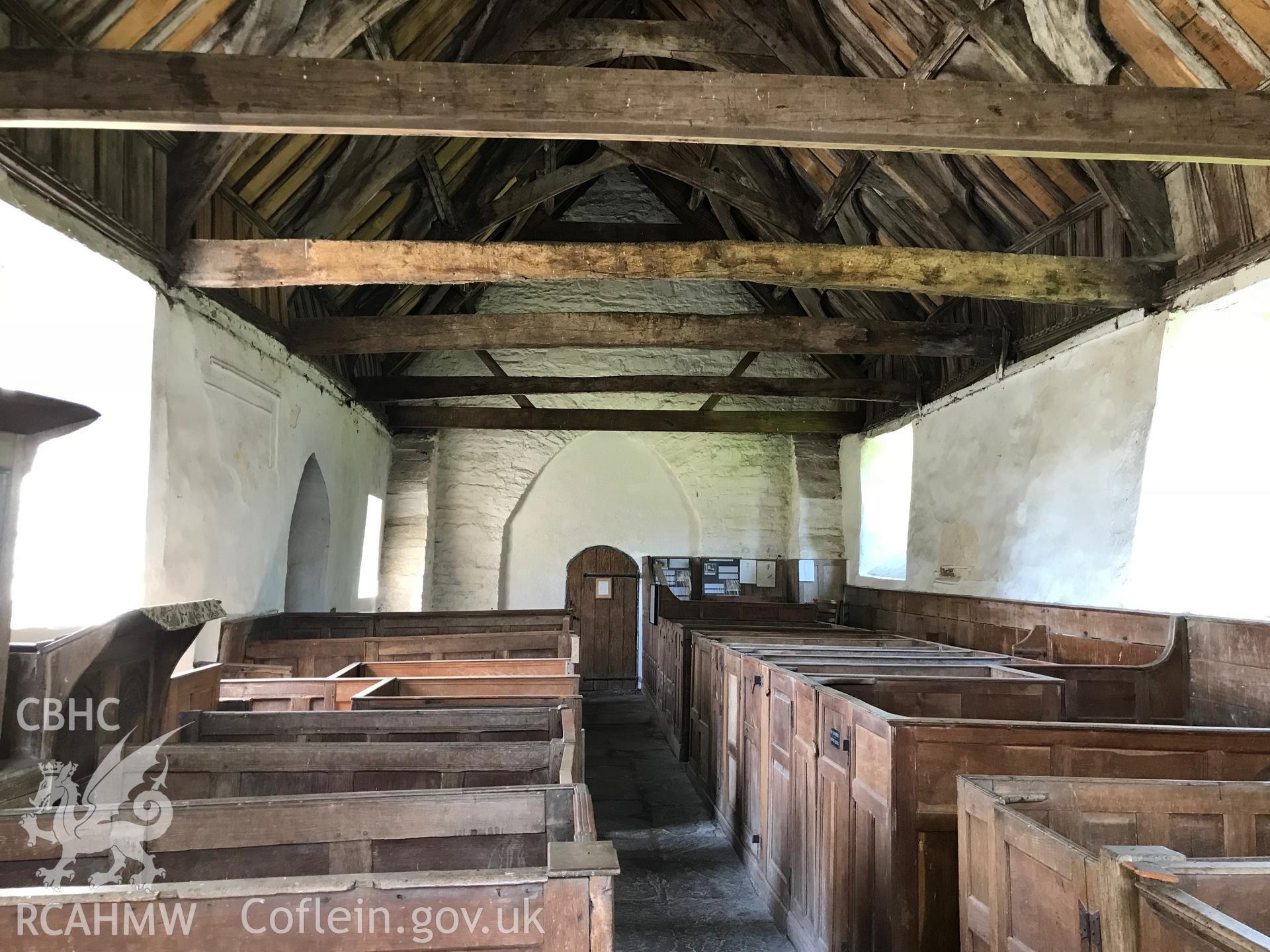 Colour photo showing interior view of St. Cewydd's Church, Diserth, including wooden pews and roof beams, taken by Paul R. Davis, 19th May 2018.