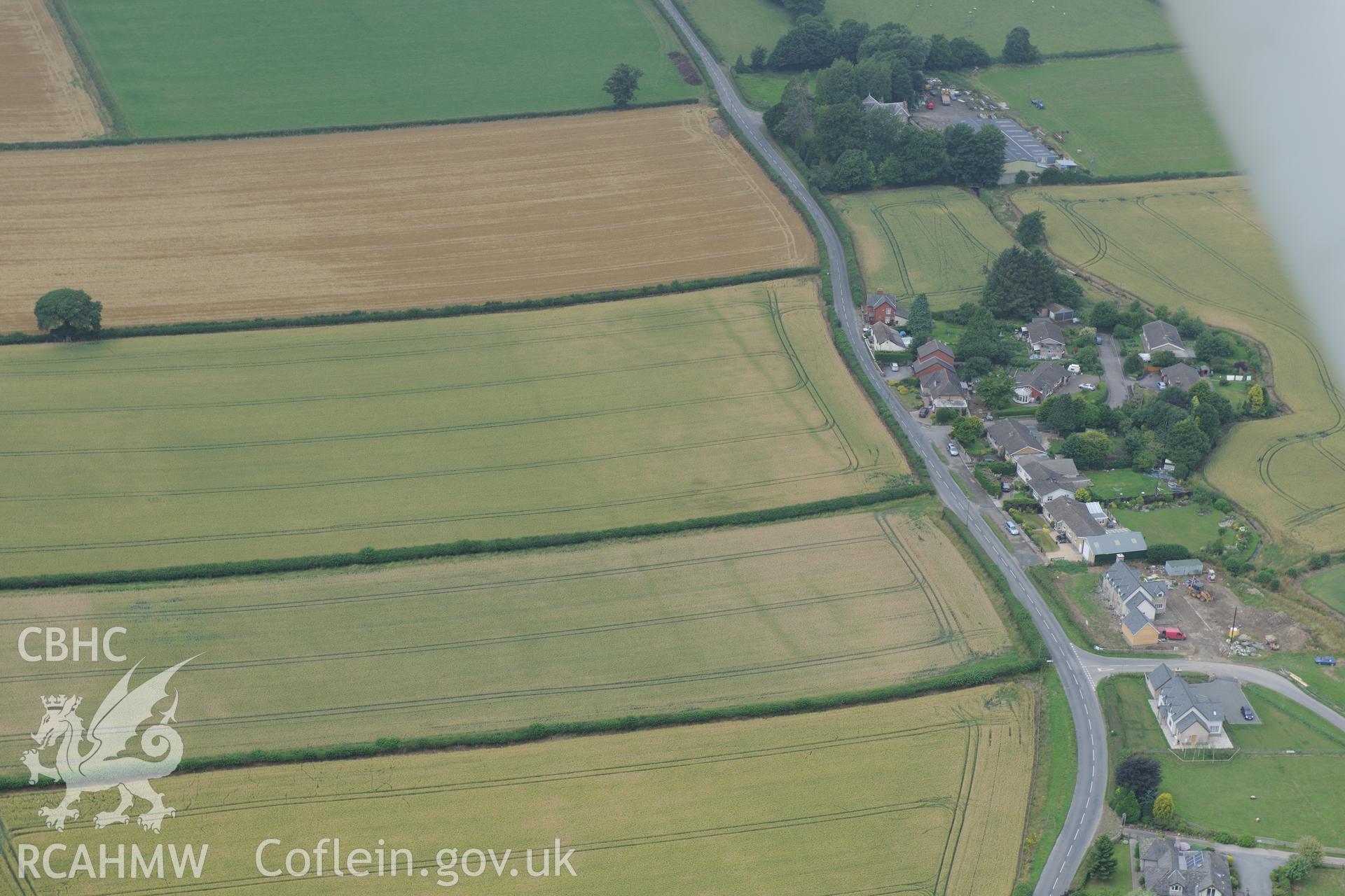 Walton Green cursus and cropmark enclosure south of the vicarage at Walton Green, south west of Presteigne. Oblique aerial photograph taken during the Royal Commission?s programme of archaeological aerial reconnaissance by Toby Driver on 1st August 2013.