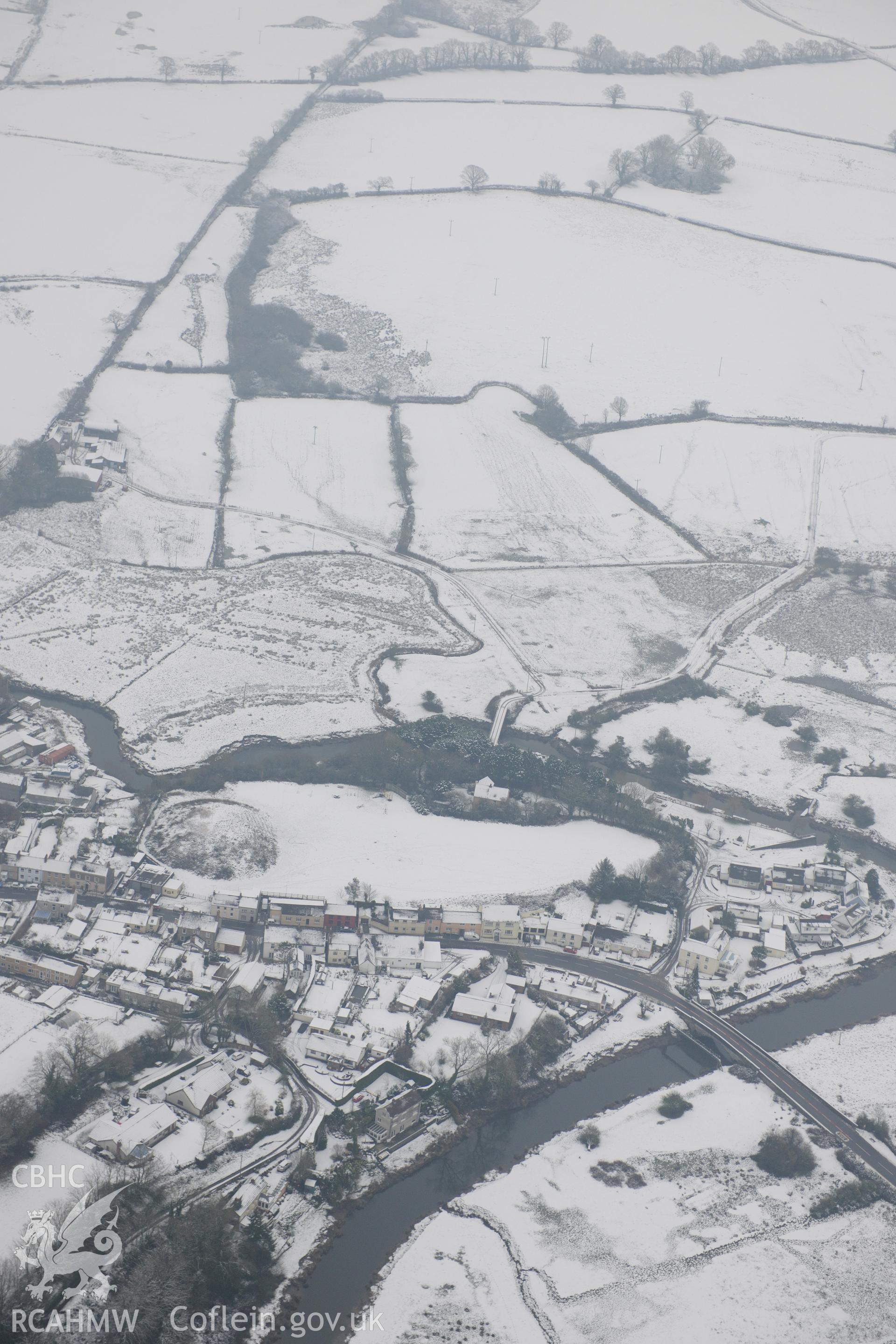 St Clears Castle and Pont St Clears, crossing the river Taff, St Clears. Oblique aerial photograph taken during the Royal Commission?s programme of archaeological aerial reconnaissance by Toby Driver on 24th January 2013.