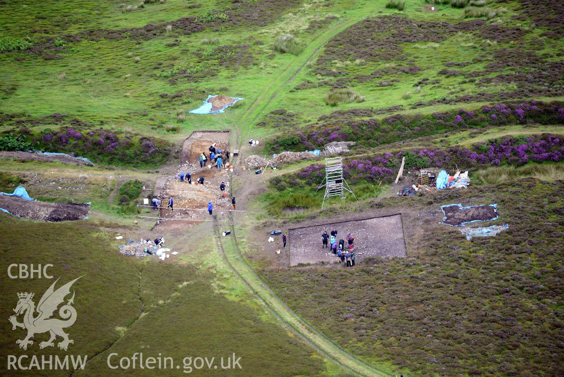 Penycloddiau Hilfort and Hut Platform V, Llangwyfan. Excavation by Liverpool University. Oblique aerial photograph taken during the Royal Commission's programme of archaeological aerial reconnaissance by Toby Driver on 30th July 2015.