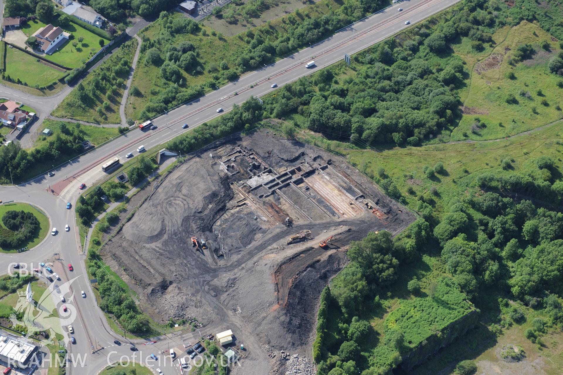 Site of former Rotax factory, Cyfarthfa Retail Park, and Cyfarthfa Ironworks including the remains of its blast furnaces, under excavation by Glamorgan-Gwent Archaeological Trust. Oblique aerial photograph taken during the Royal Commission?s programme of