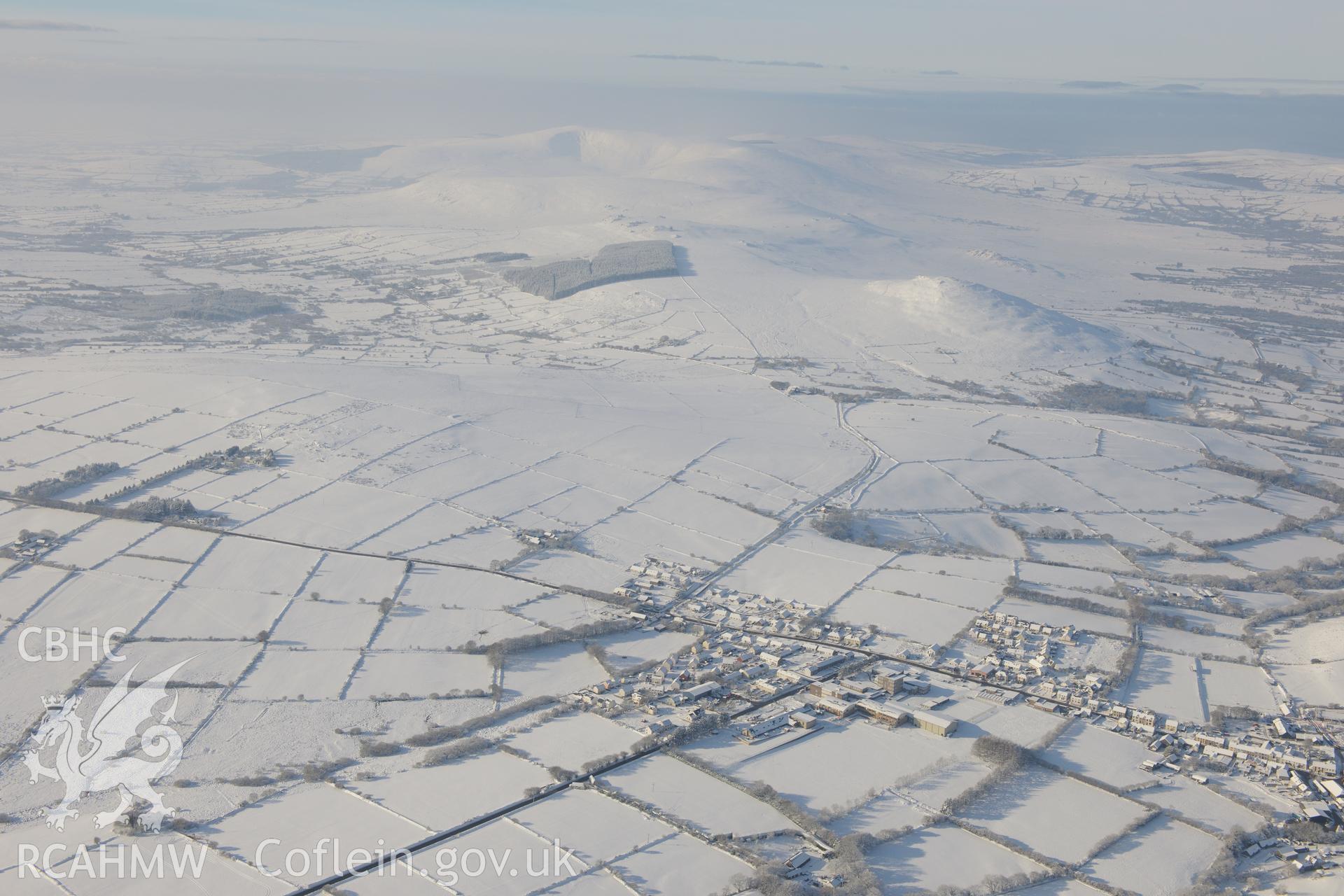 Foel Drygarn hillfort and the town of Crymych. Oblique aerial photograph taken during the Royal Commission?s programme of archaeological aerial reconnaissance by Toby Driver on 24th January 2013.