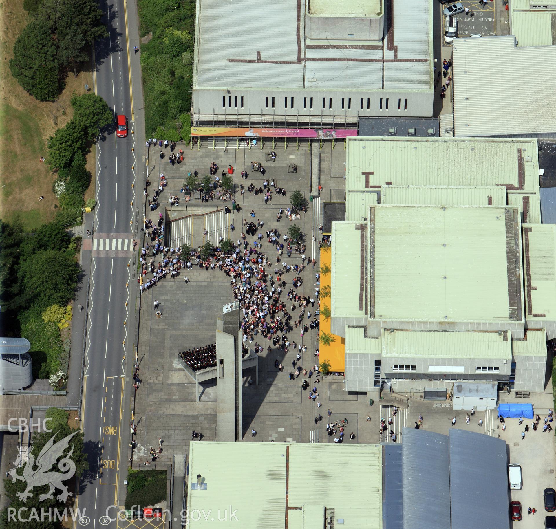 Aberystwyth Arts Centre on Graduation Day. Oblique aerial photograph taken during the Royal Commission?s programme of archaeological aerial reconnaissance by Toby Driver on  12th July 2013.