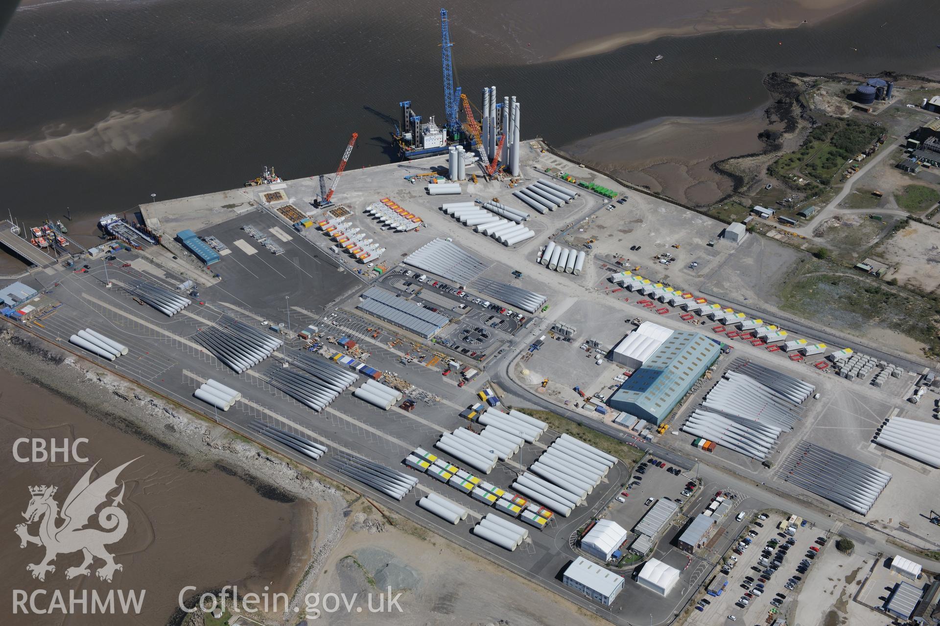 Mostyn Quay in the port of Mostyn, with windfarm parts. Oblique aerial photograph taken during the Royal Commission?s programme of archaeological aerial reconnaissance by Toby Driver on 22nd May 2013.