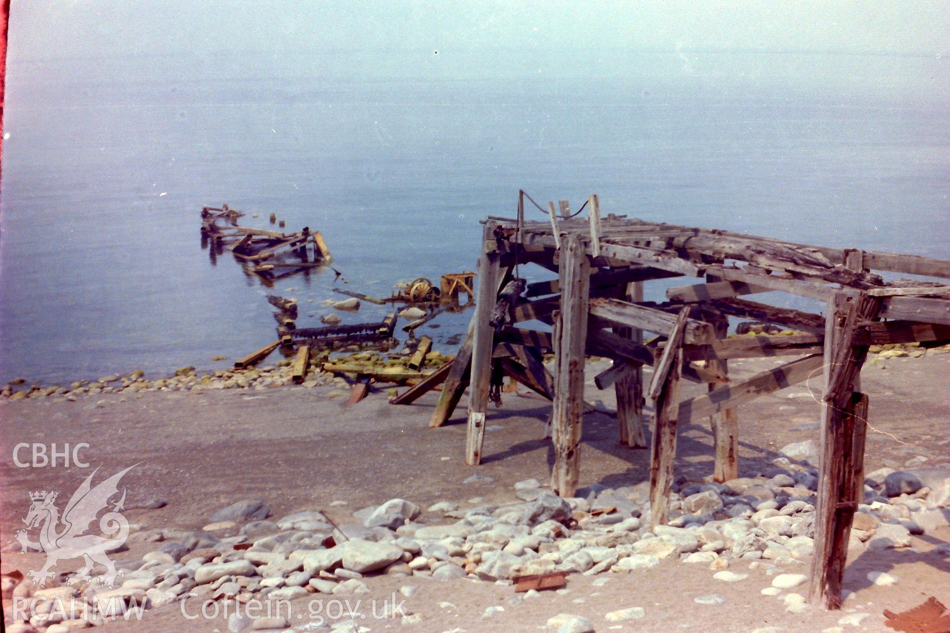 Digitised colour photograph of a jetty at Porth-y-Nant. Produced during a Bachelor of Architecture dissertation: 'The Form & Architecture of Nineteenth Century Industrial Settlements in Rural Wales' by Martin Davies, 1979.