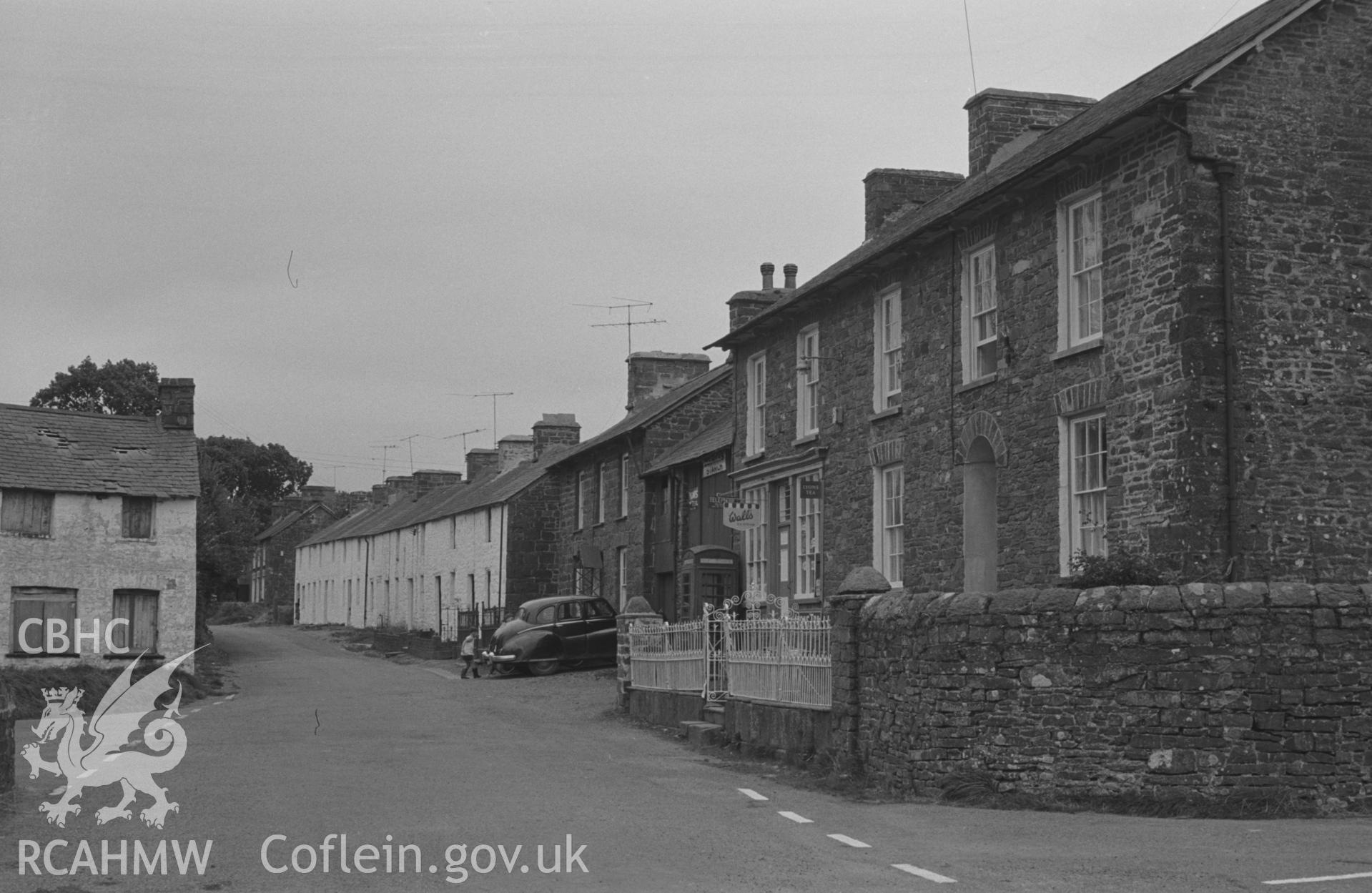 Digital copy of a black and white negative showing view along the Cwmsaeson road from the crossroads in the centre of Oakford village. Photographed by Arthur O. Chater on 5th September 1966 looking south east from Grid Reference SN 452 580.