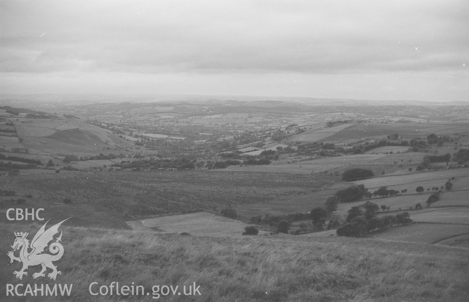 Digital copy of a black and white negative showing view down the Ffrwd Cynon valley from Esgair Fraith, east of Lampeter. Photographed by Arthur O. Chater in August 1965 from Grid Reference SN 6481 4823, looking west.