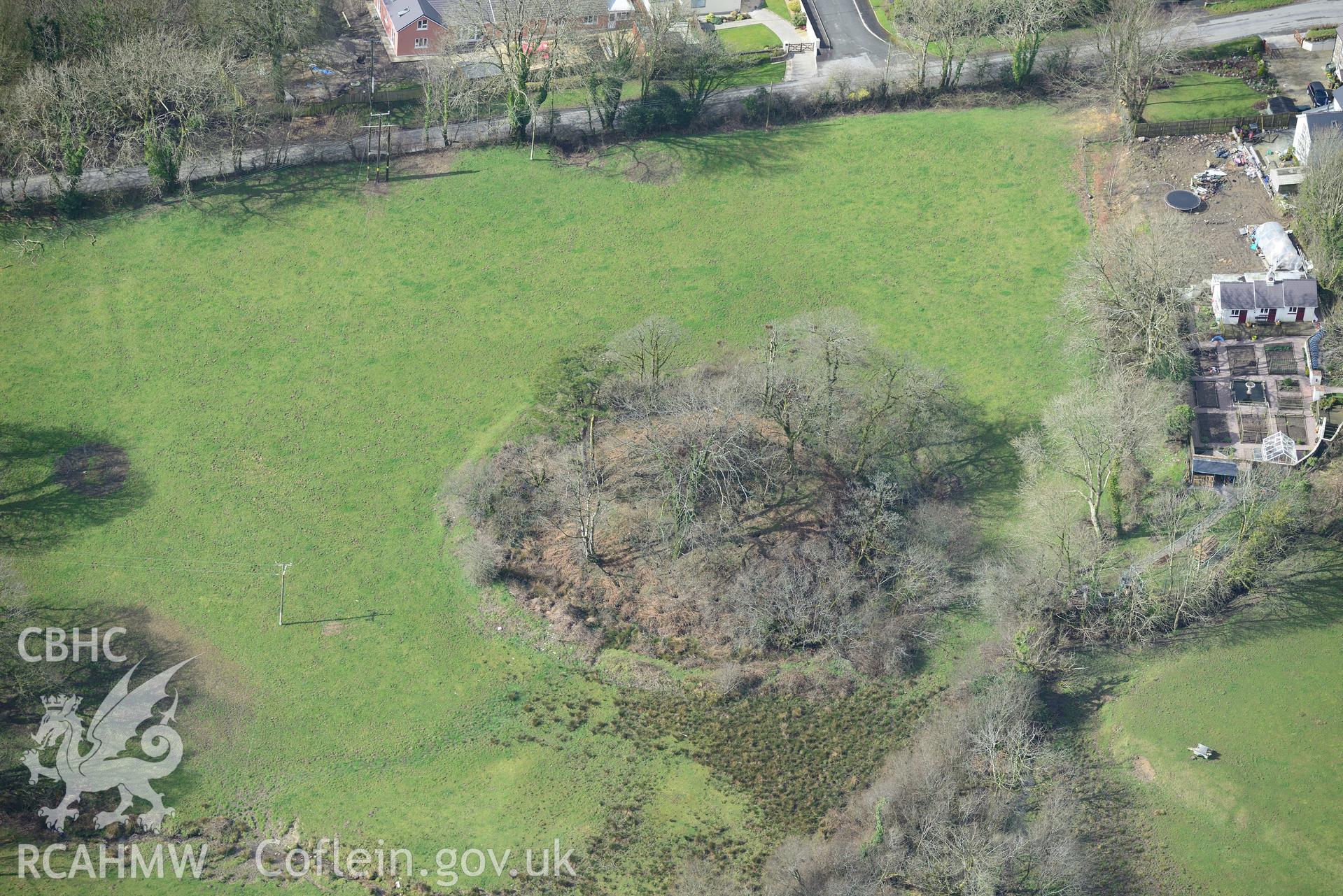 New Moat Castle motte and bailey, New Moat, near Haverfordwest. Oblique aerial photograph taken during the Royal Commission's programme of archaeological aerial reconnaissance by Toby Driver on 13th March 2015.