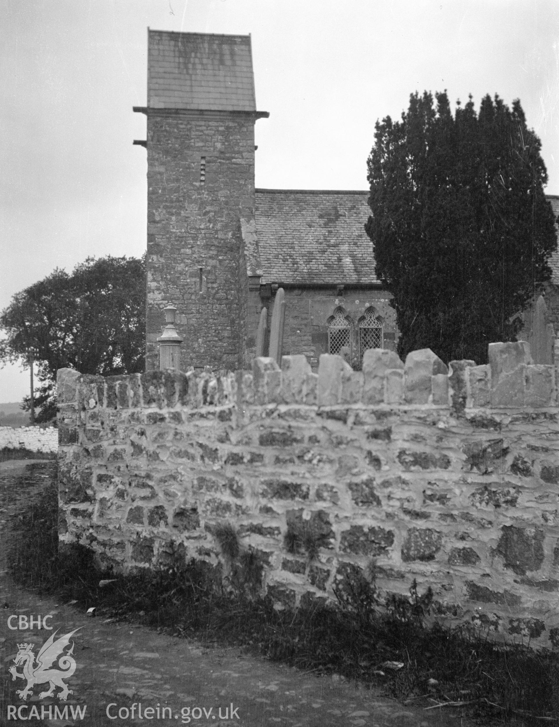 Digital copy of a nitrate negative showing exterior view of church and saddle-back tower from the south, St Teilo's Church, Pendine. From the National Building Record Postcard Collection.