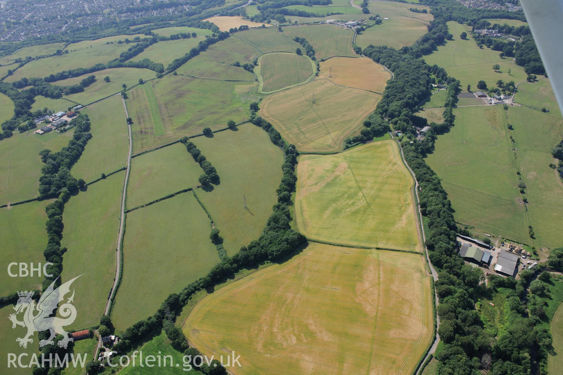 Malthouse Road defended enclosures, and Graig-yr-Eurych castle mound, north west of Caerleon. Oblique aerial photograph taken during the Royal Commission?s programme of archaeological aerial reconnaissance by Toby Driver on 1st August 2013.