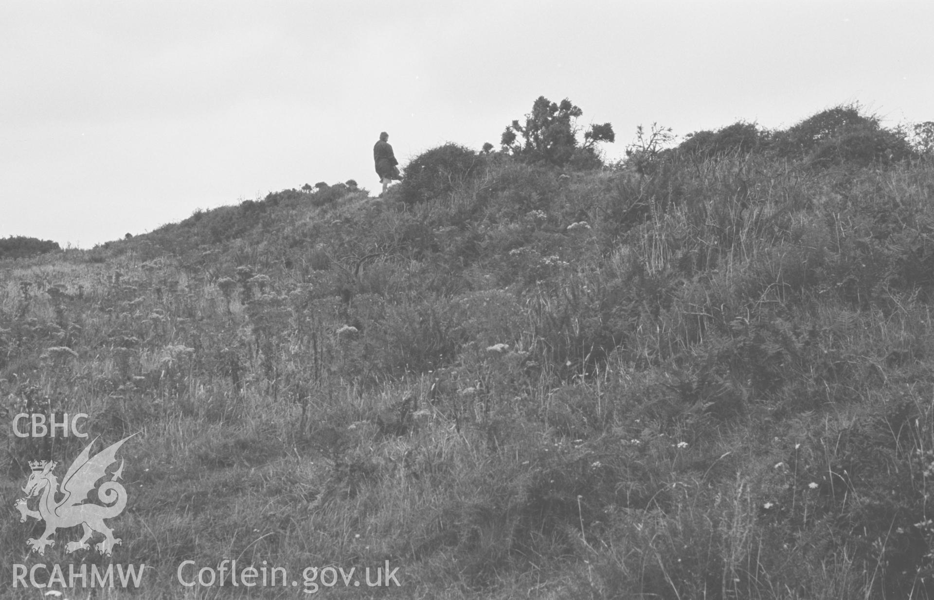 Digital copy of a black and white negative showing Castell Bach iron age camp, 1km south west of Llangrannog. Photographed by Arthur O. Chater on 10th September 1966 from Grid Reference c. SN 303 536.