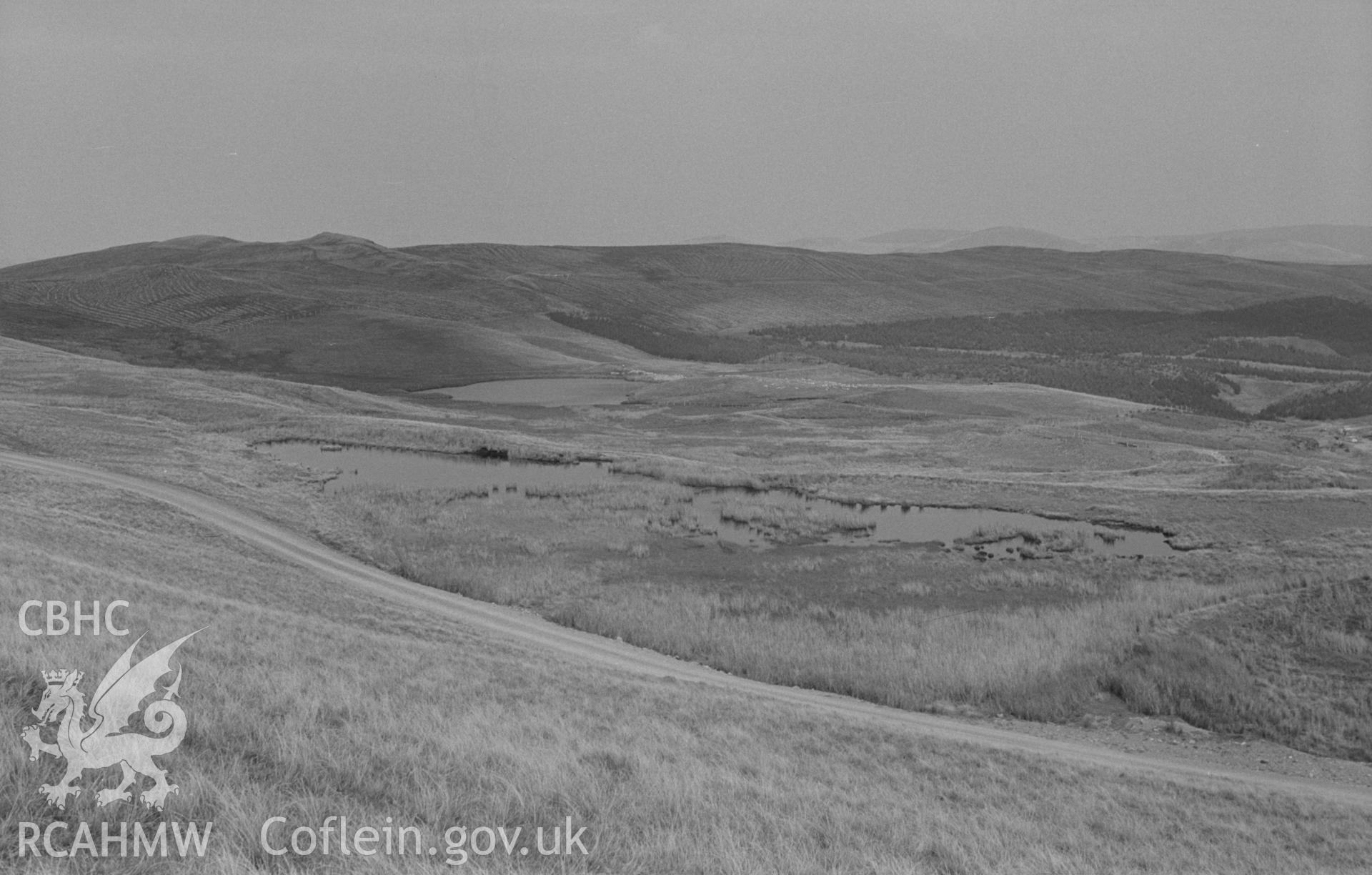 Digital copy of a black and white negative showing panorama of Esgair-Hir mine from Banc Bwlchgarreg; old reservoir on left. Photographed by Arthur O. Chater on 22nd August 1967, looking east from Grid Reference SN 732 913. (Photograph 1 of 3).