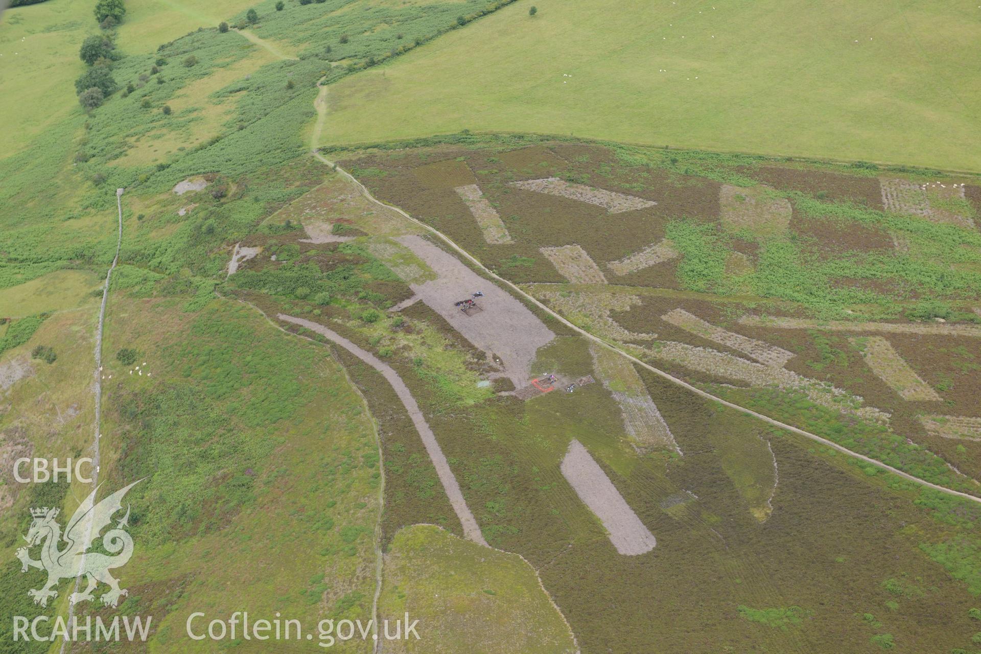 Moel Arthur Hillfort, showing views of boundary stone, spoil tip and pit. Excavation by Liverpool University. Oblique aerial photograph taken during the Royal Commission?s programme of archaeological aerial reconnaissance by Toby Driver on 30th July 2015.