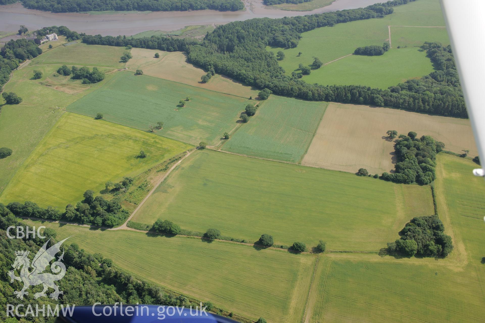 Circular cropmark at Slebech Park, east of Haverfordwest. Oblique aerial photograph taken during the Royal Commission?s programme of archaeological aerial reconnaissance by Toby Driver on 16th July 2013.