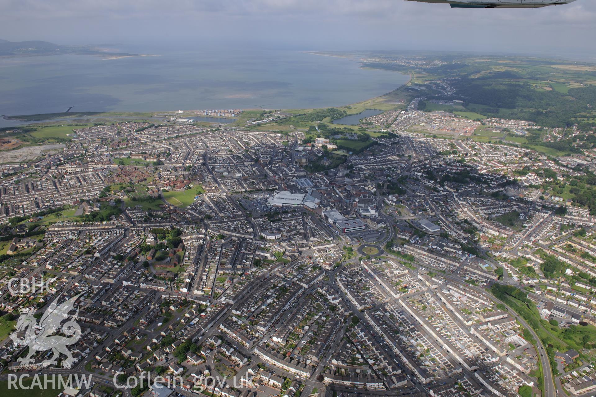 Landscape view of the town of Llanelli including the north dock and St. Elli's shopping centre, Llanelli. Oblique aerial photograph taken during the Royal Commission's programme of archaeological aerial reconnaissance by Toby Driver on 19th June 2015.