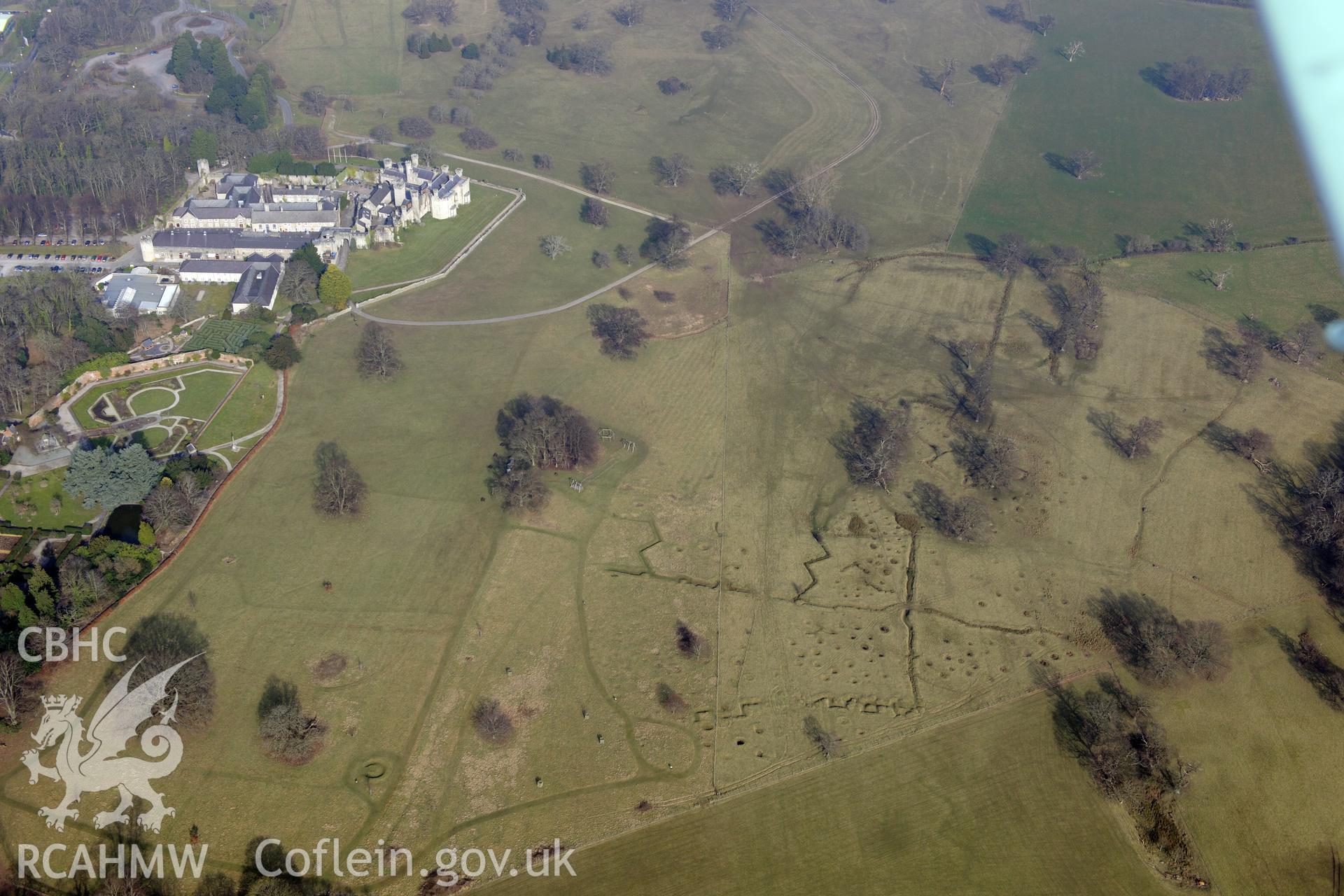 Bodelwyddan Castle, its garden, and Bodelwyddan Park army practise trenches, west of St. Asaph. Oblique aerial photograph taken during the Royal Commission?s programme of archaeological aerial reconnaissance by Toby Driver on 28th February 2013.