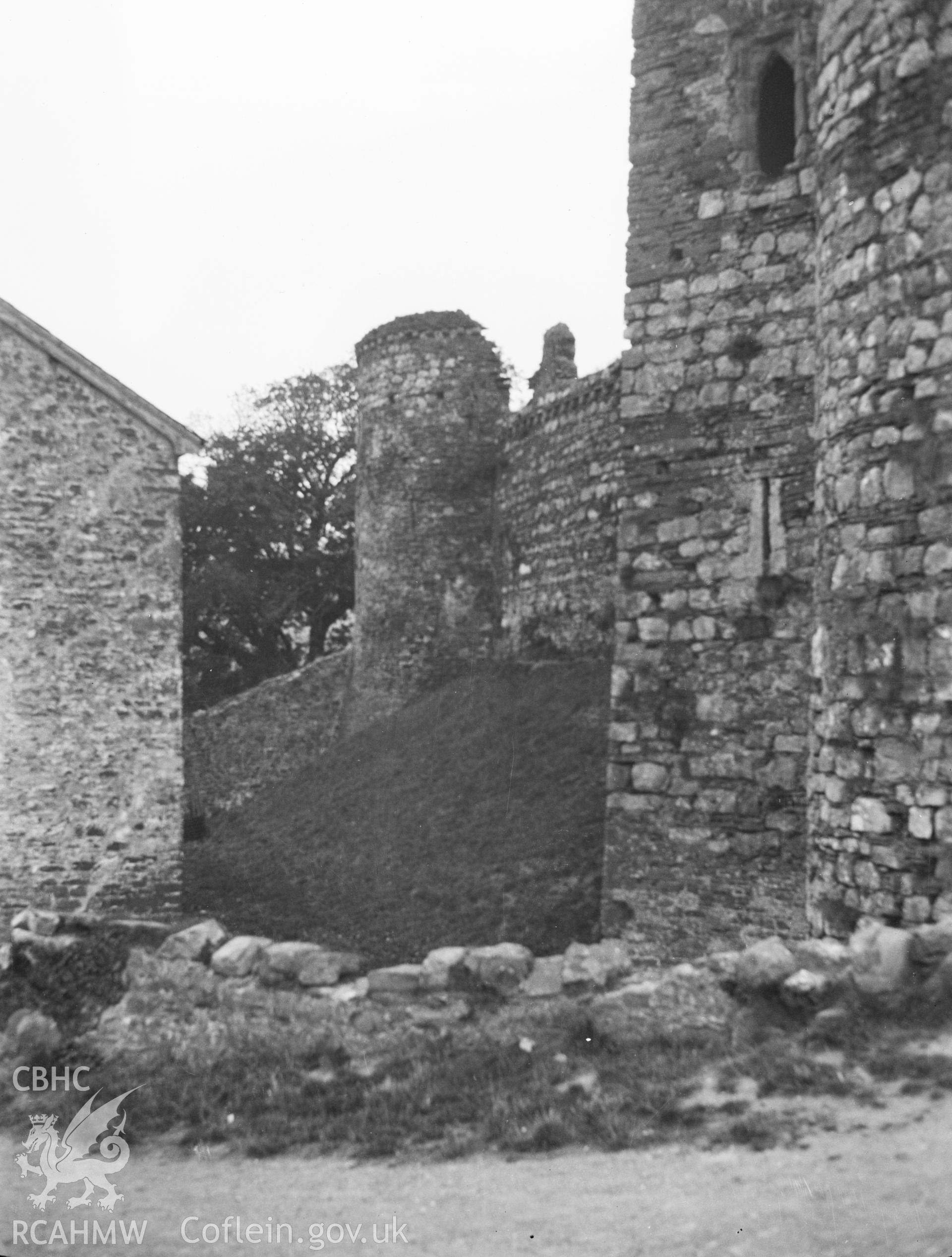 Digital copy of a nitrate negative showing exterior view of south west drum tower and part of curtain wall, Kidwelly Castle. From the National Building Record Postcard Collection.