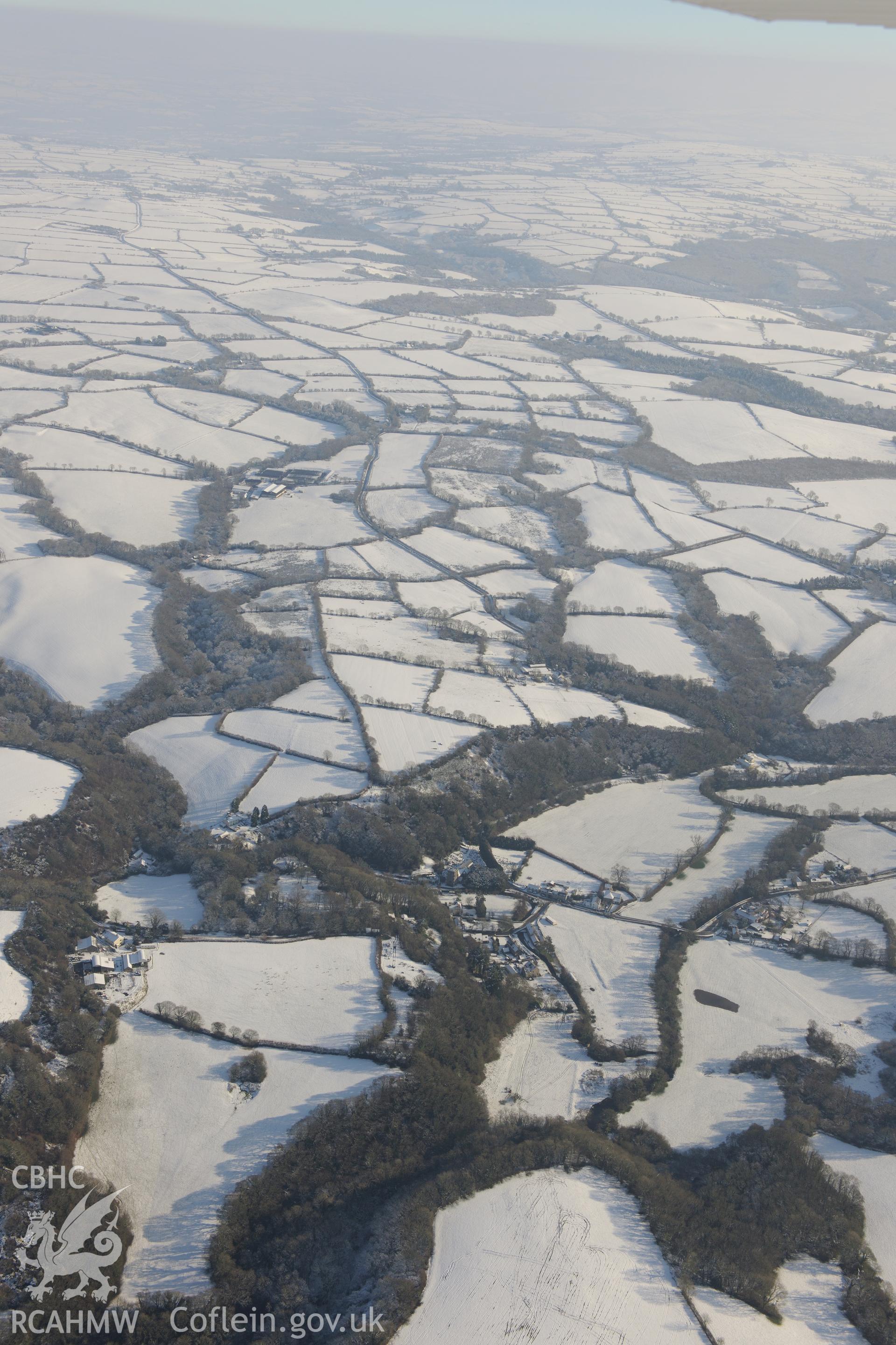 Nevern castle and the surrounding town, between Cardigan and Fishguard. Oblique aerial photograph taken during the Royal Commission?s programme of archaeological aerial reconnaissance by Toby Driver on 24th January 2013.