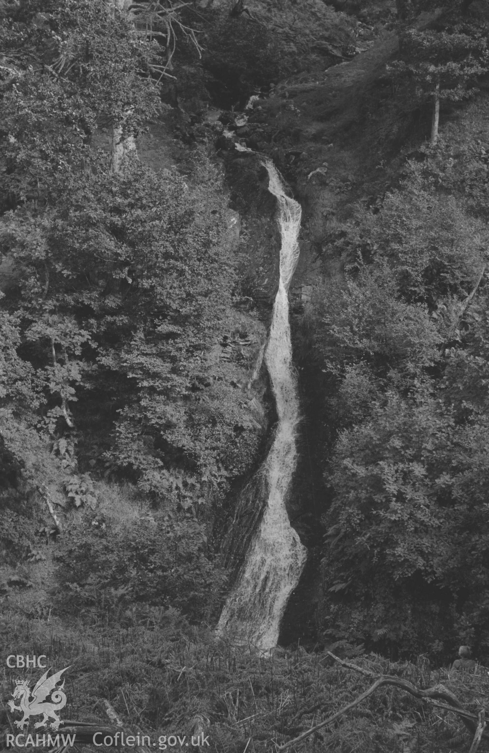 Digital copy of a black and white negative showing waterfall on tributary stream flowing into Nant Gau 600m south east of Dolgau. Photographed by Arthur O. Chater in September 1964 from Grid Reference SN 7751 7278, looking east.