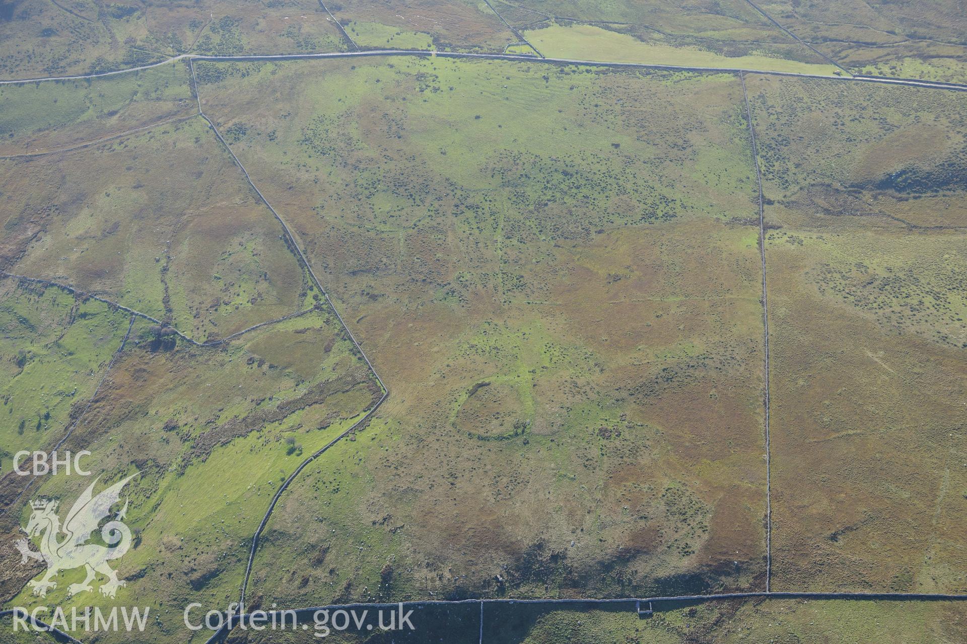 An enclosure at Morfa and hut circles south east of Mynydd Craig Wen, near Fairbourne. Oblique aerial photograph taken during the Royal Commission's programme of archaeological aerial reconnaissance by Toby Driver on 2nd October 2015.