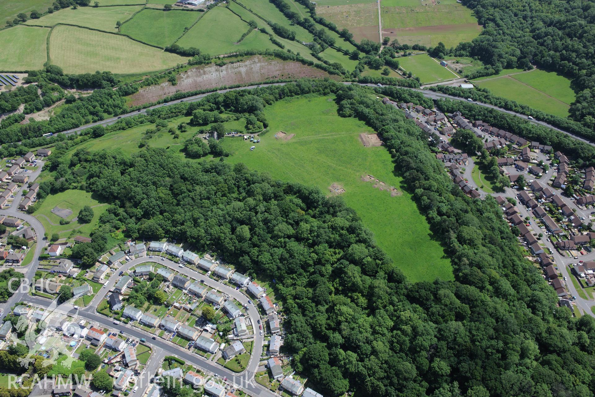 Caerau village and the excavation of Caerau Hillfort, Ely, conducted by Cardiff University. Oblique aerial photograph taken during the Royal Commission's programme of archaeological aerial reconnaissance by Toby Driver on 29th June 2015.