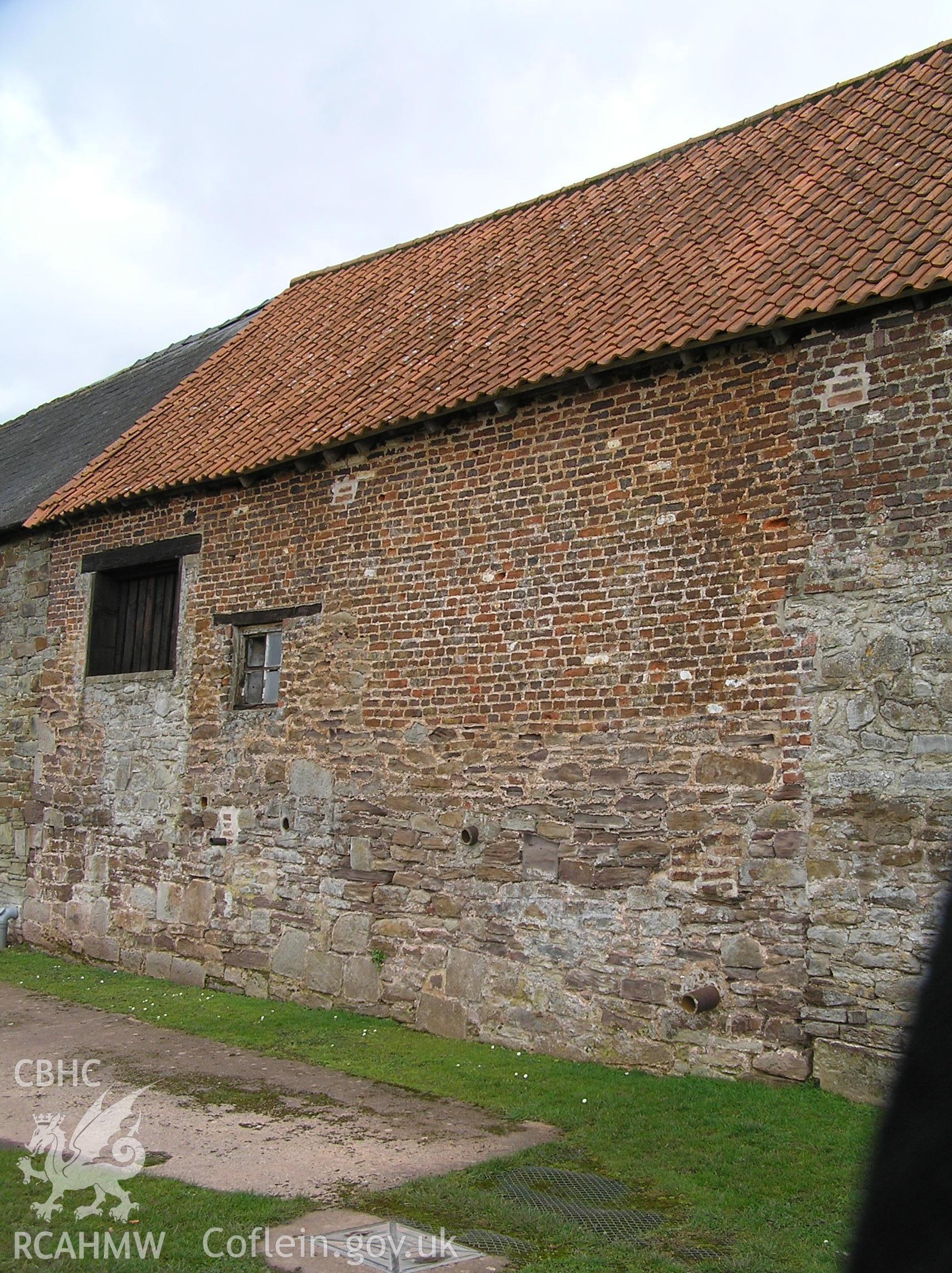 Colour photo showing the north end of the west elevation of the cowhouse, taken by John Wheelock and donated as a condition of planning consent.