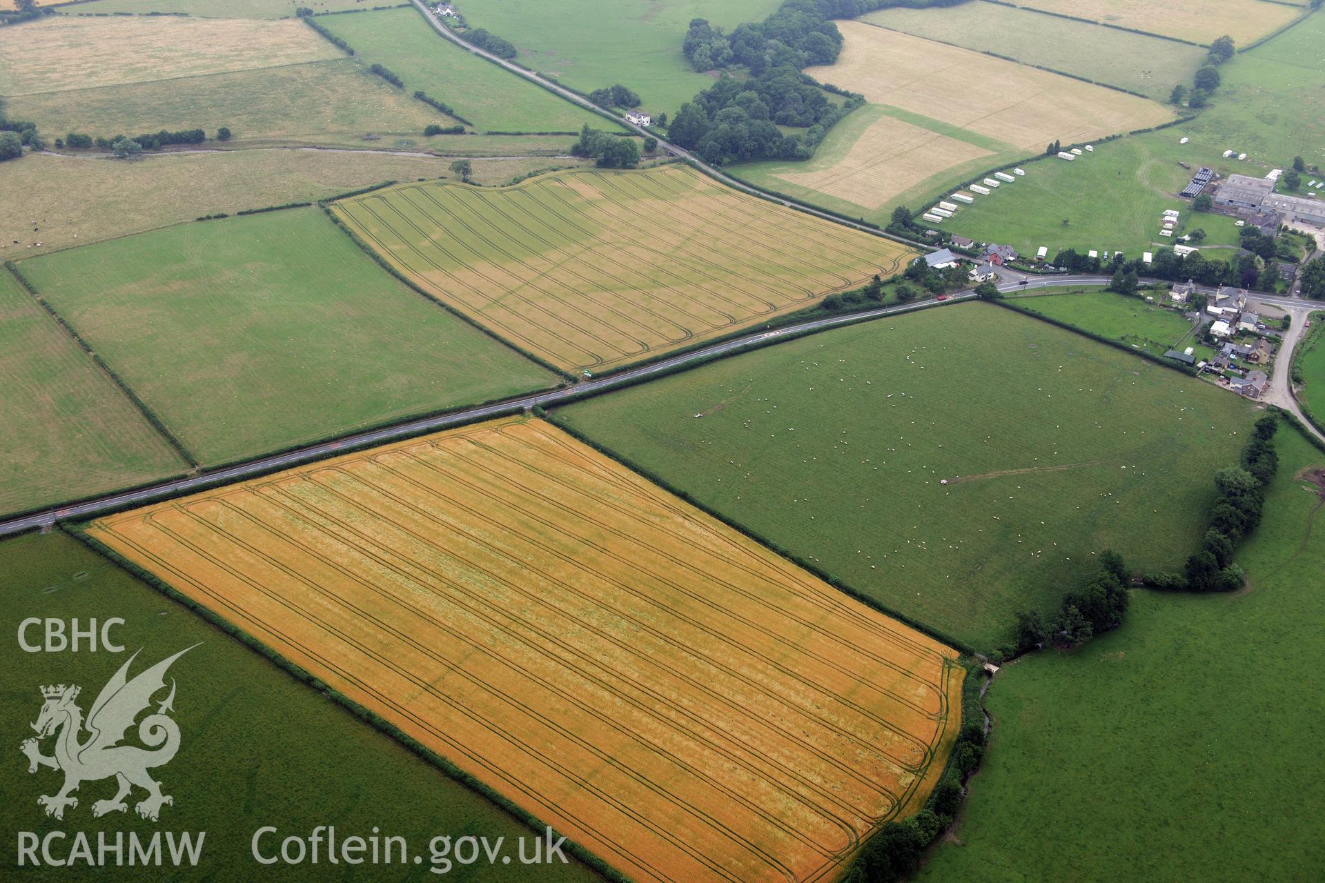 Walton Roman Camp III, Walton Court farmstead & cropmark enclosure north of Ridding Brook, south west of Presteigne. Oblique aerial photograph taken during Royal Commission?s programme of archaeological aerial reconnaissance by Toby Driver, 1st Aug 2013.