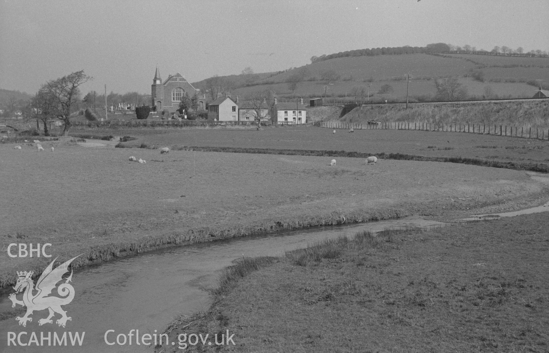 Digital copy of black & white negative showing Brondeifi chapel, Lampeter, with railway line beyond and Lletytwpa Wood on top of hill on left. Photograph by Arthur Chater, 12 April 1967 looking north from bridge over afon Dulas and Teifi at SN 581 476.