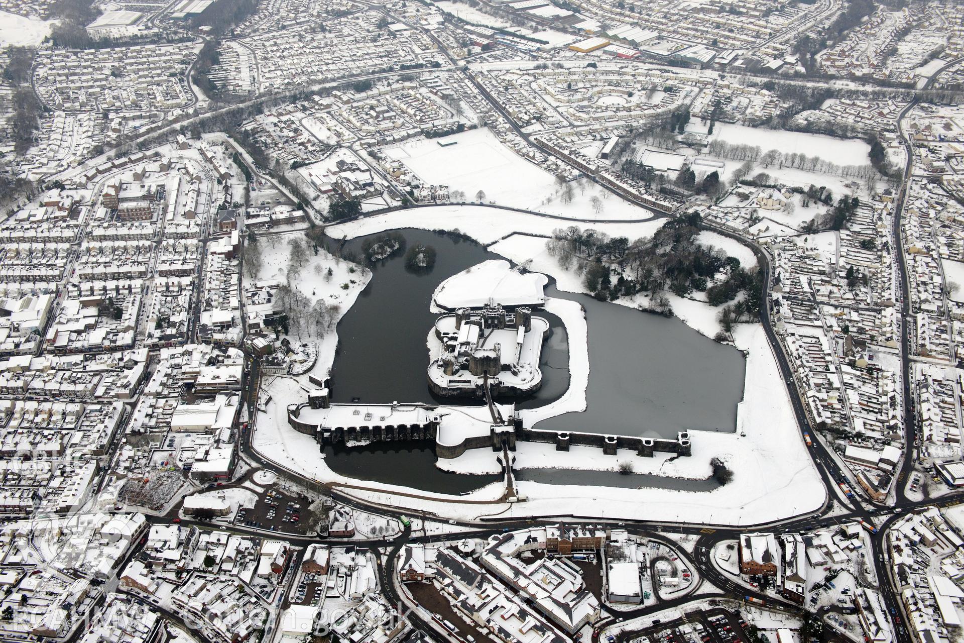 Caerphilly Castle and the town of Caerphilly. Oblique aerial photograph taken during the Royal Commission?s programme of archaeological aerial reconnaissance by Toby Driver on 24th January 2013.