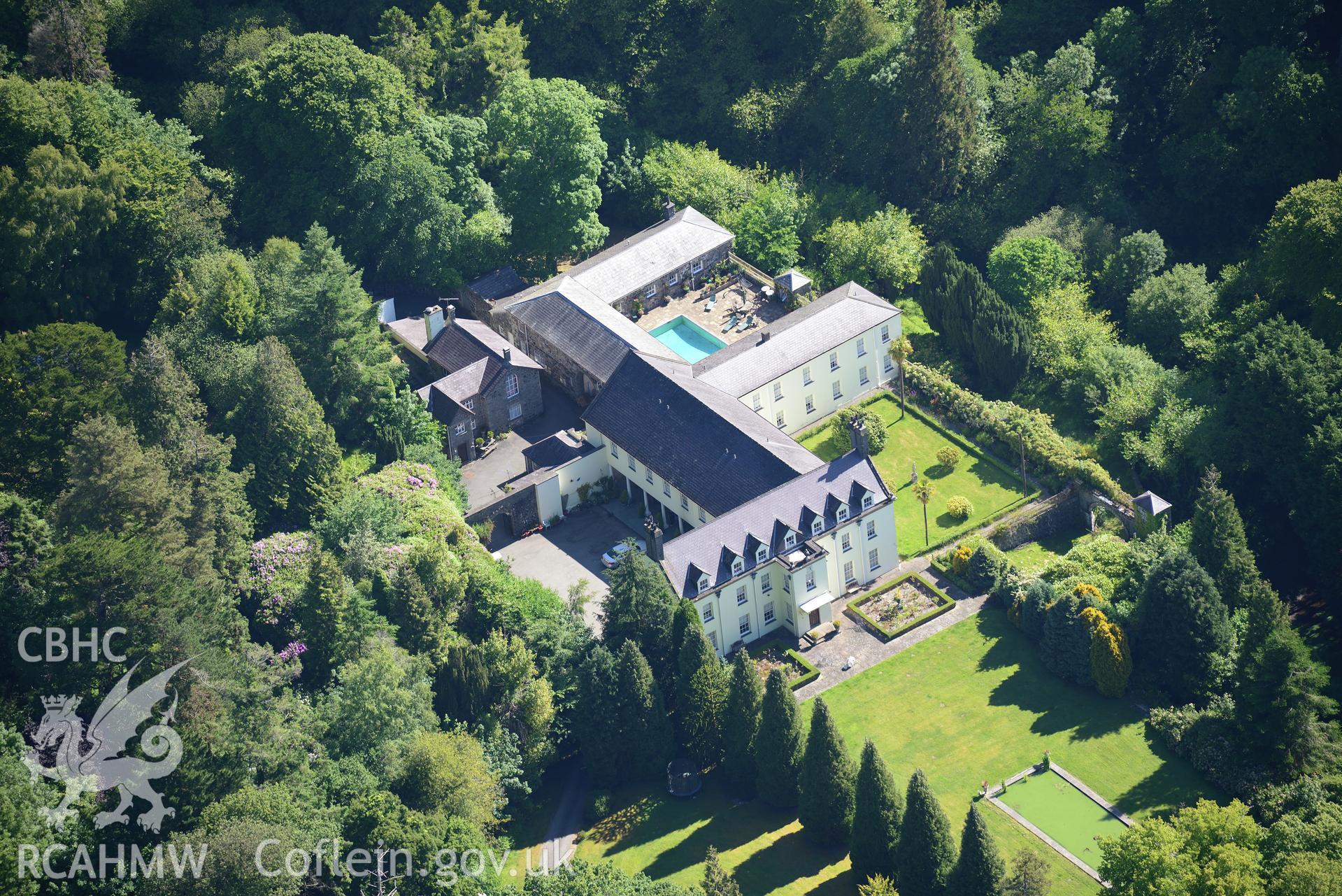 Plas Boduan surrounded by its park and gardens. Oblique aerial photograph taken during the Royal Commission's programme of archaeological aerial reconnaissance by Toby Driver on 23rd June 2015.