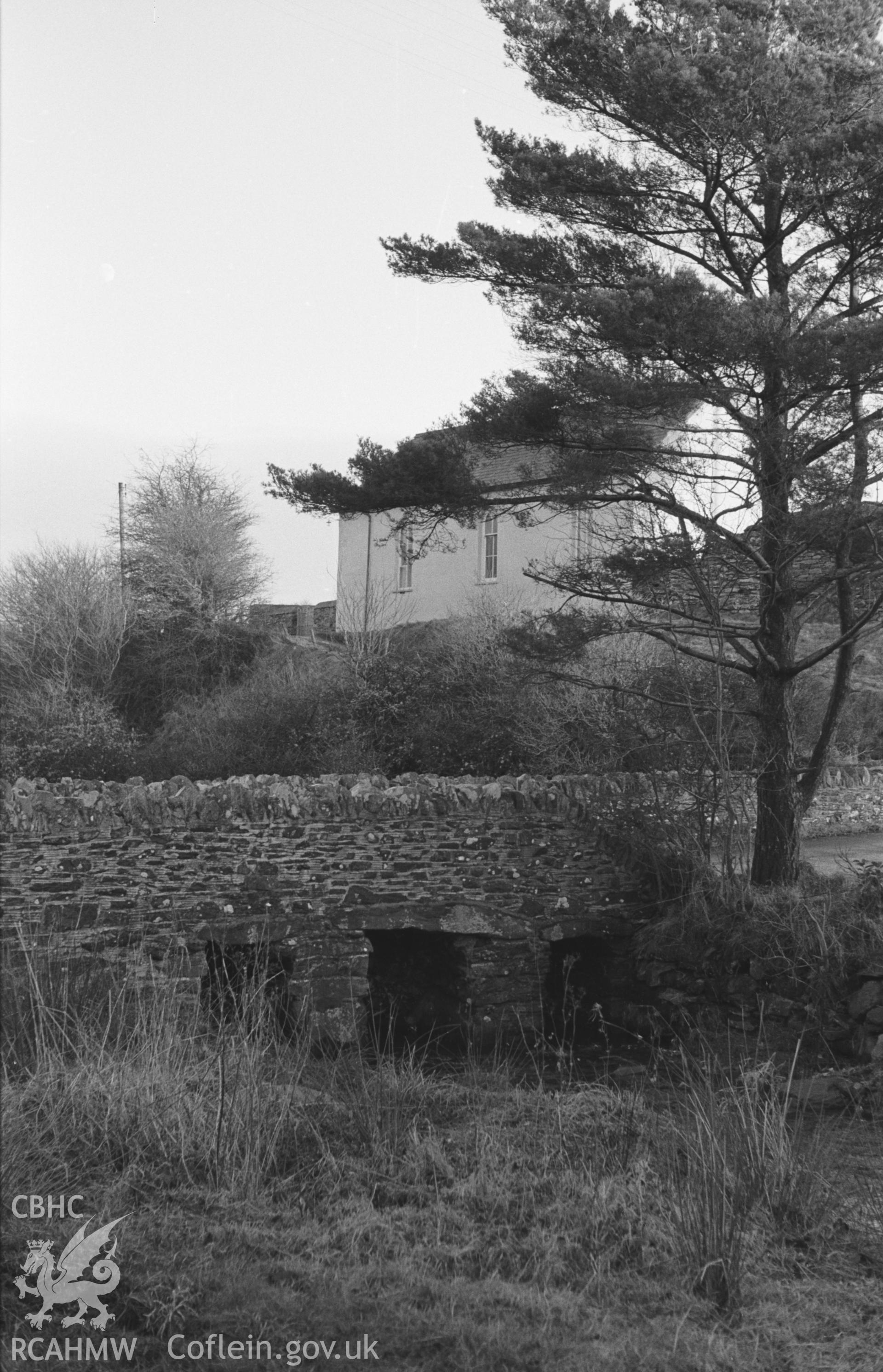 Digital copy of black & white negative of view looking upstream to bridge leading to Bethel Welsh Baptist Chapel in Swyddffynnon, north of Tregaron. Photograph by Arthur O. Chater, December 1963  from Grid Reference SN 6934 6618, looking west north west.