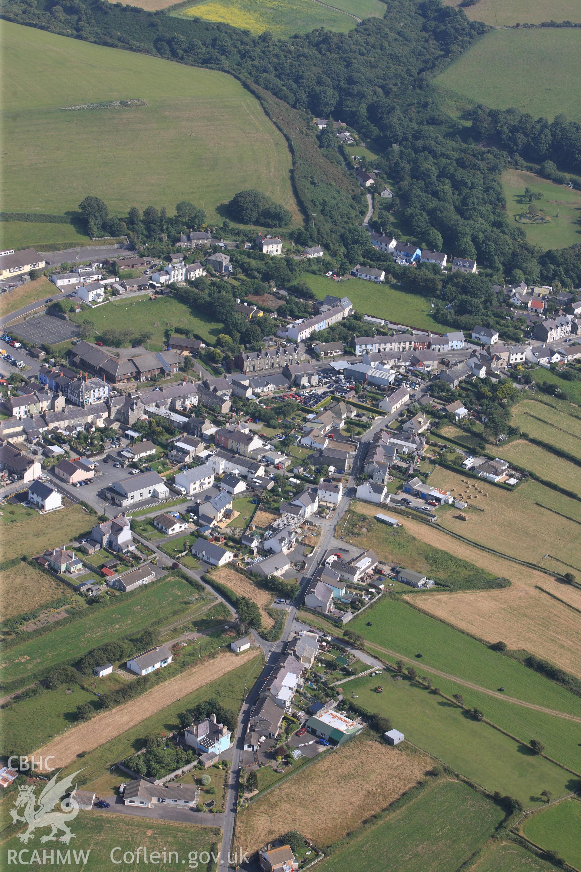 The village of Llanon, Ceredigion, including view of Llanon field system. Oblique aerial photograph taken during the Royal Commission?s programme of archaeological aerial reconnaissance by Toby Driver on 12th July 2013.