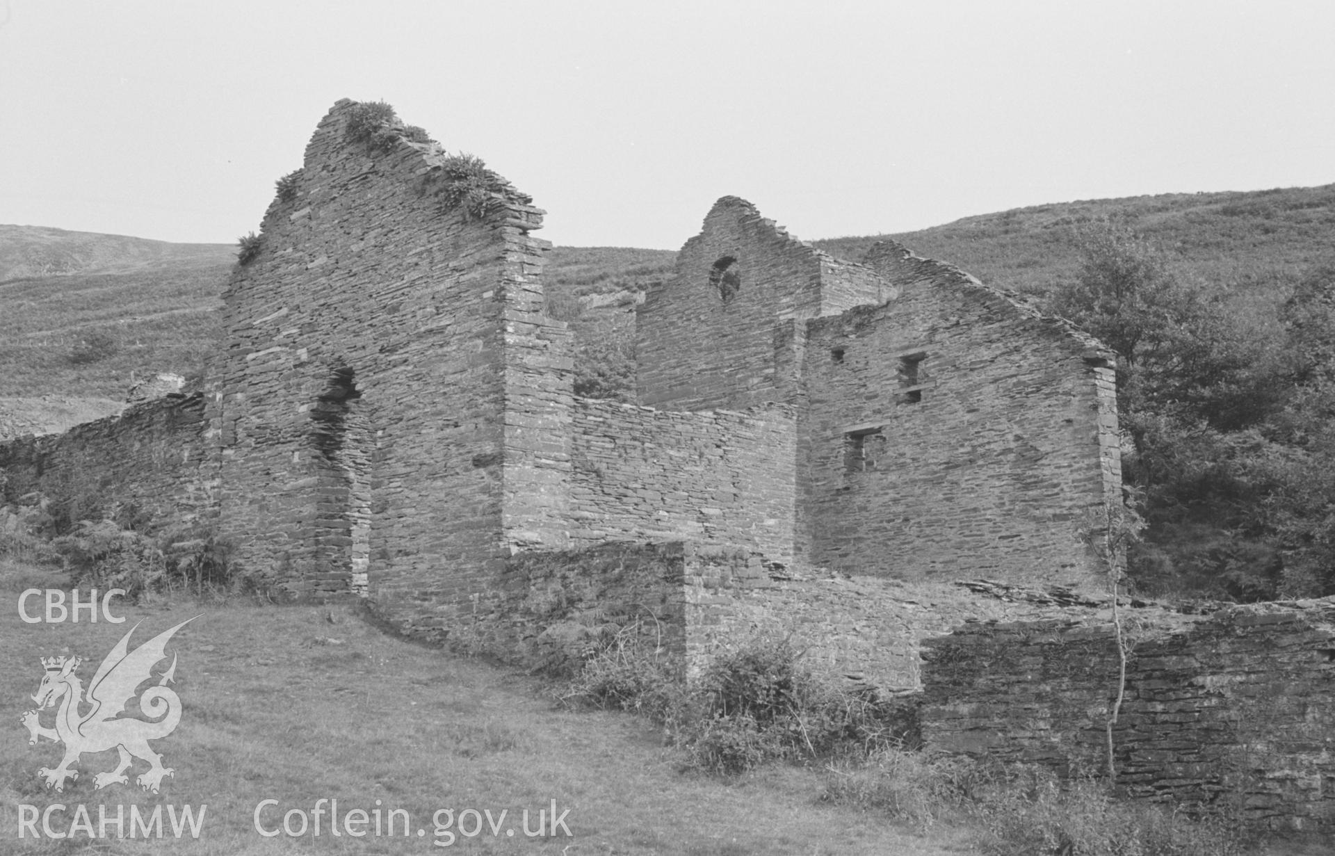 Digital copy of black & white negative showing ruins of the main mine buildings at Bryndyfi Lead Mine, Eglwysfach, Machynlleth. Dressing floors on the right. Photographed by Arthur O. Chater in August 1966 from Grid Reference SN 683 934, looking east.