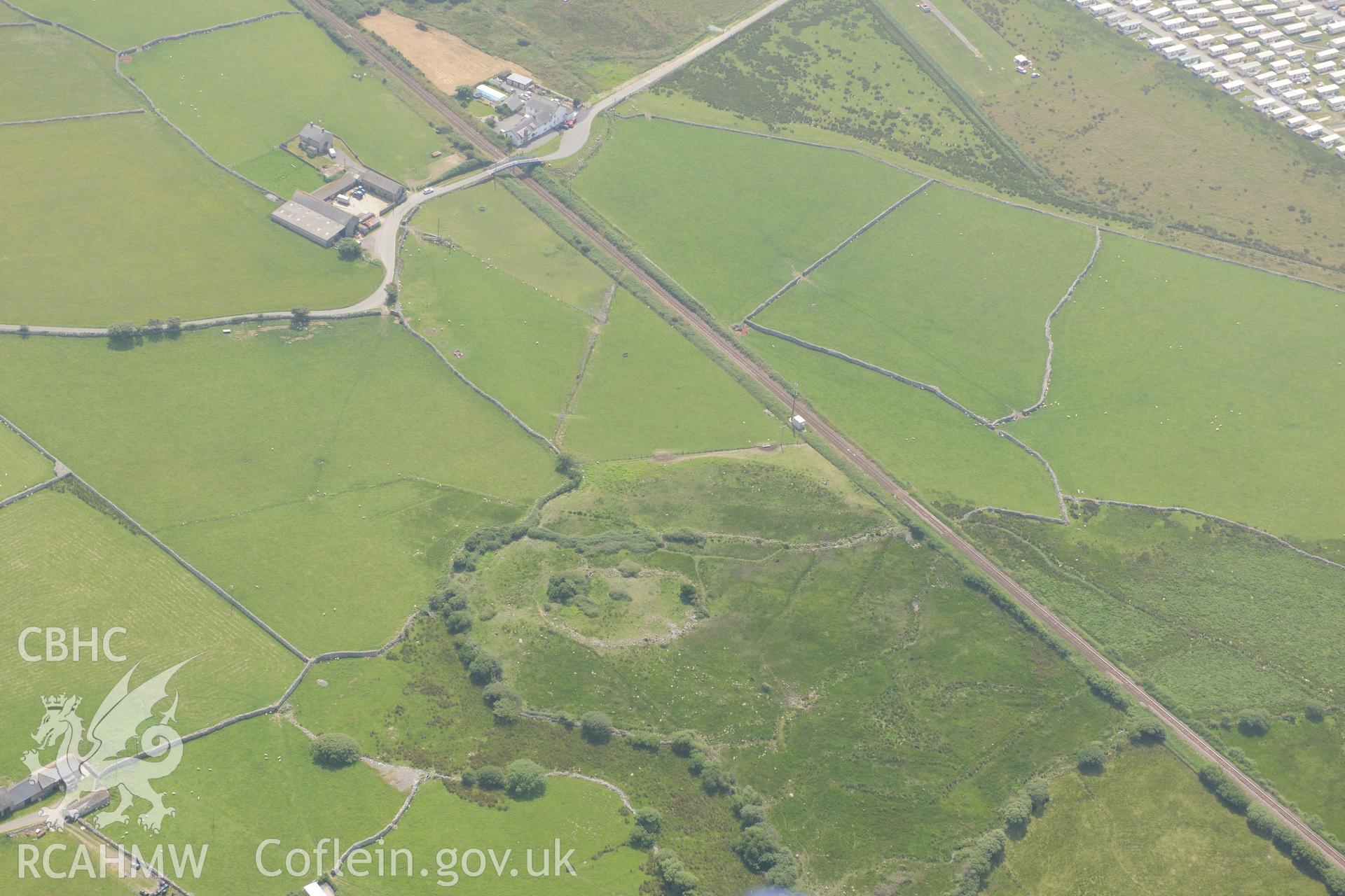 Sebonig homestead, and a section of the Cambrian Coast railway line, south of Dyffryn Ardudwy. Oblique aerial photograph taken during the Royal Commission?s programme of archaeological aerial reconnaissance by Toby Driver on 12th July 2013.