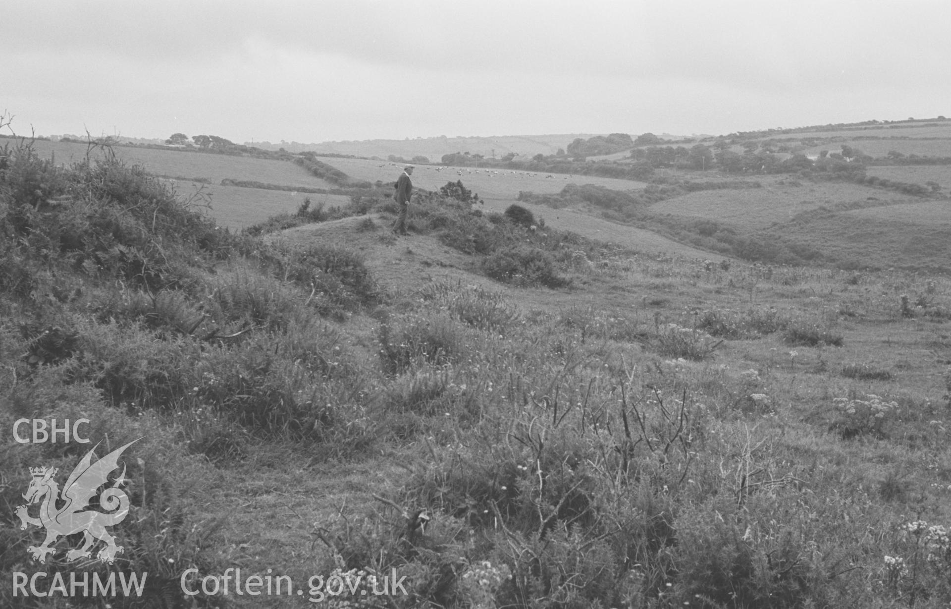 Digital copy of a black and white negative showing bank at right angles to main rampart of Castell Bach iron age promontory fort, Llangrannog. Photographed by Arthur O. Chater on 10th September 1966 looking south from Grid Reference SN 3032 5358.