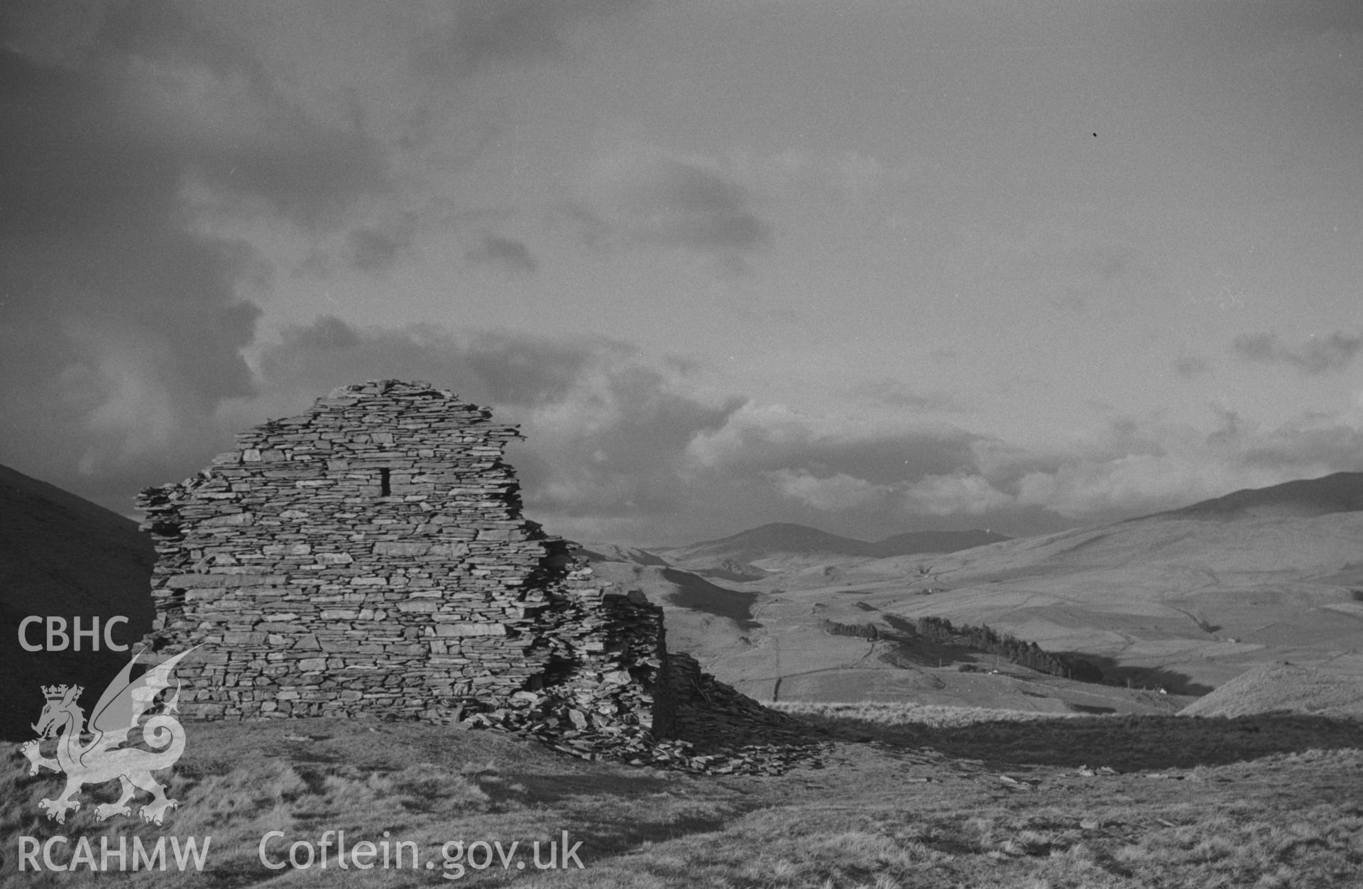 Digital copy of a black and white negative showing ruin on the east side of Ystumtuen road on the top of the Hen Riw. Photographed by Arthur O. Chater in January 1968. (Looking north from Grid Reference SN 741 797).