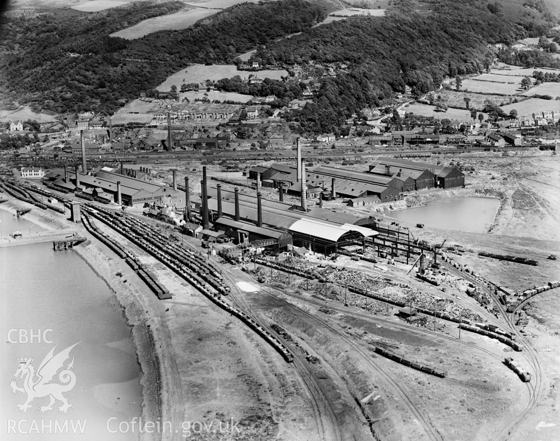 View of Baglan Bay Tinplate Co., Albion Steelworks and Whitford Works from the west (Briton Ferry), oblique aerial view. 5?x4? black and white glass plate negative.