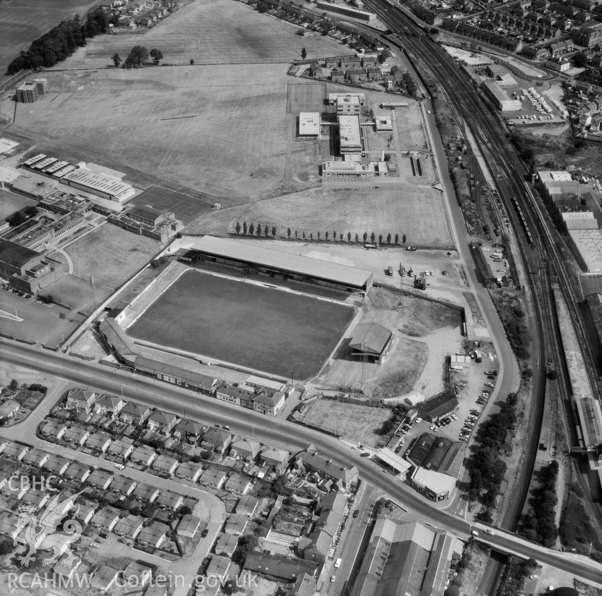 Black and white oblique aerial photograph showing the Racecourse Ground,  Wrexham,  from Aerofilms album, taken by Aerofilms Ltd and dated 1976.