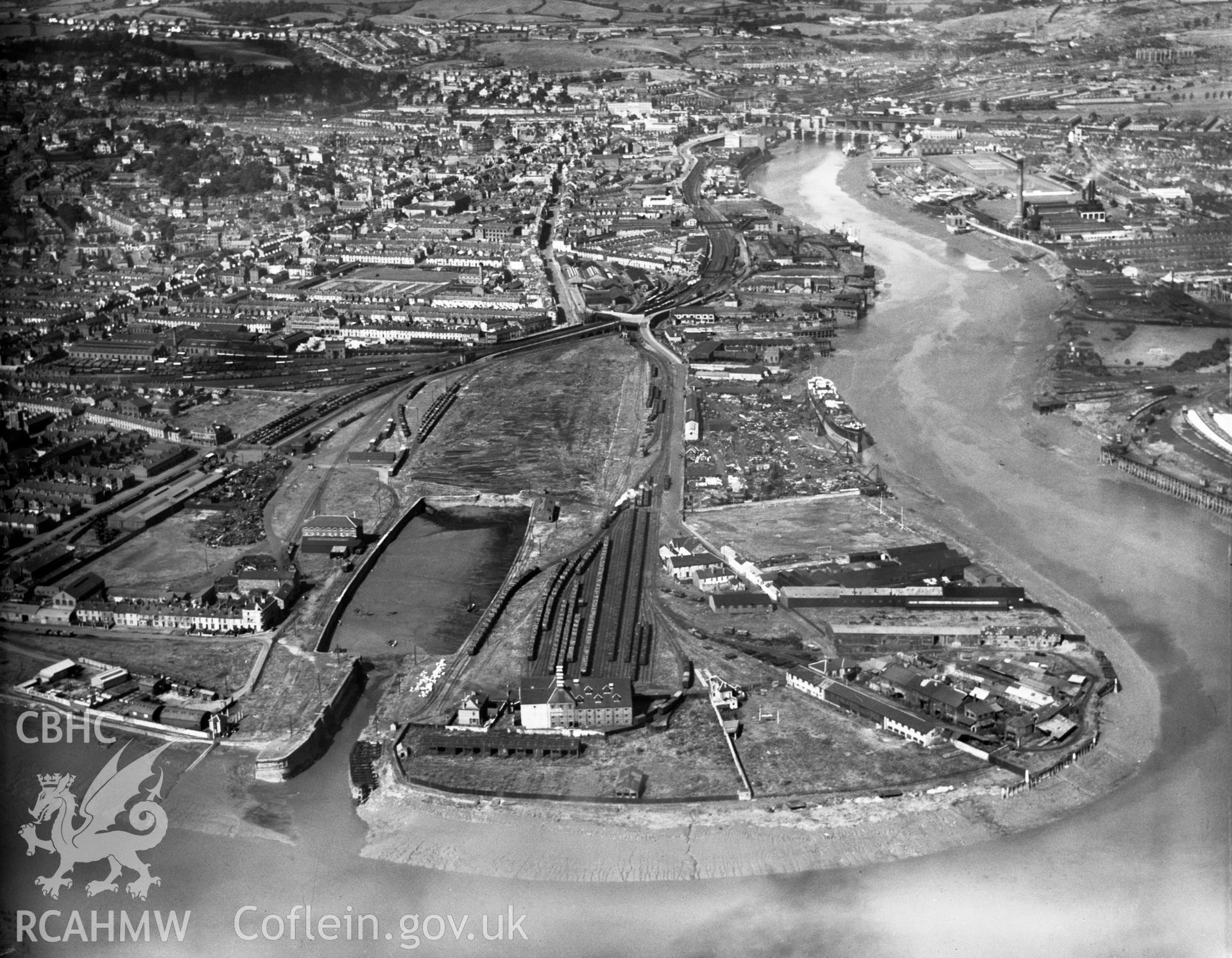 View of Newport showing town dock and warehouses, oblique aerial view. 5?x4? black and white glass plate negative.