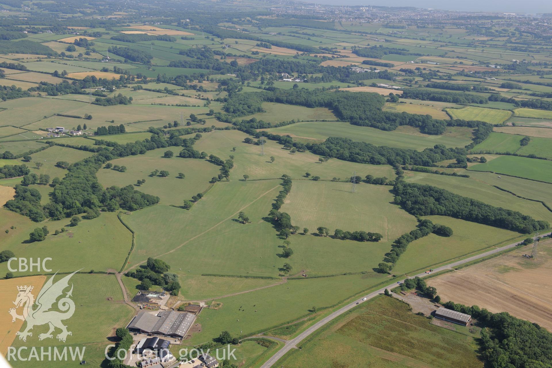 Coed-y-Cwm enclosure and chambered cairn, between Cowbridge and Cardiff. Oblique aerial photograph taken during the Royal Commission?s programme of archaeological aerial reconnaissance by Toby Driver on 1st August 2013.