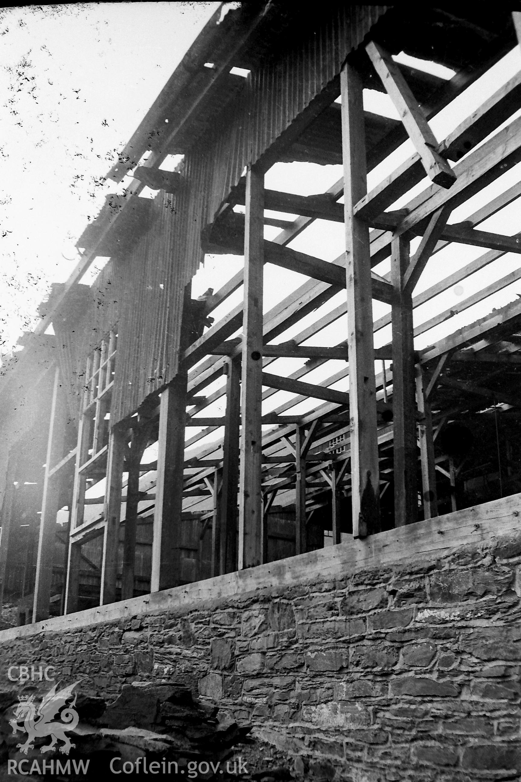 Digitised black and white photograph showing 'works shed construction, Cwmystwyth.' Photographed by Martin Davies as part of his Bachelor of Architecture dissertation from the University of Nottingham, 1979.