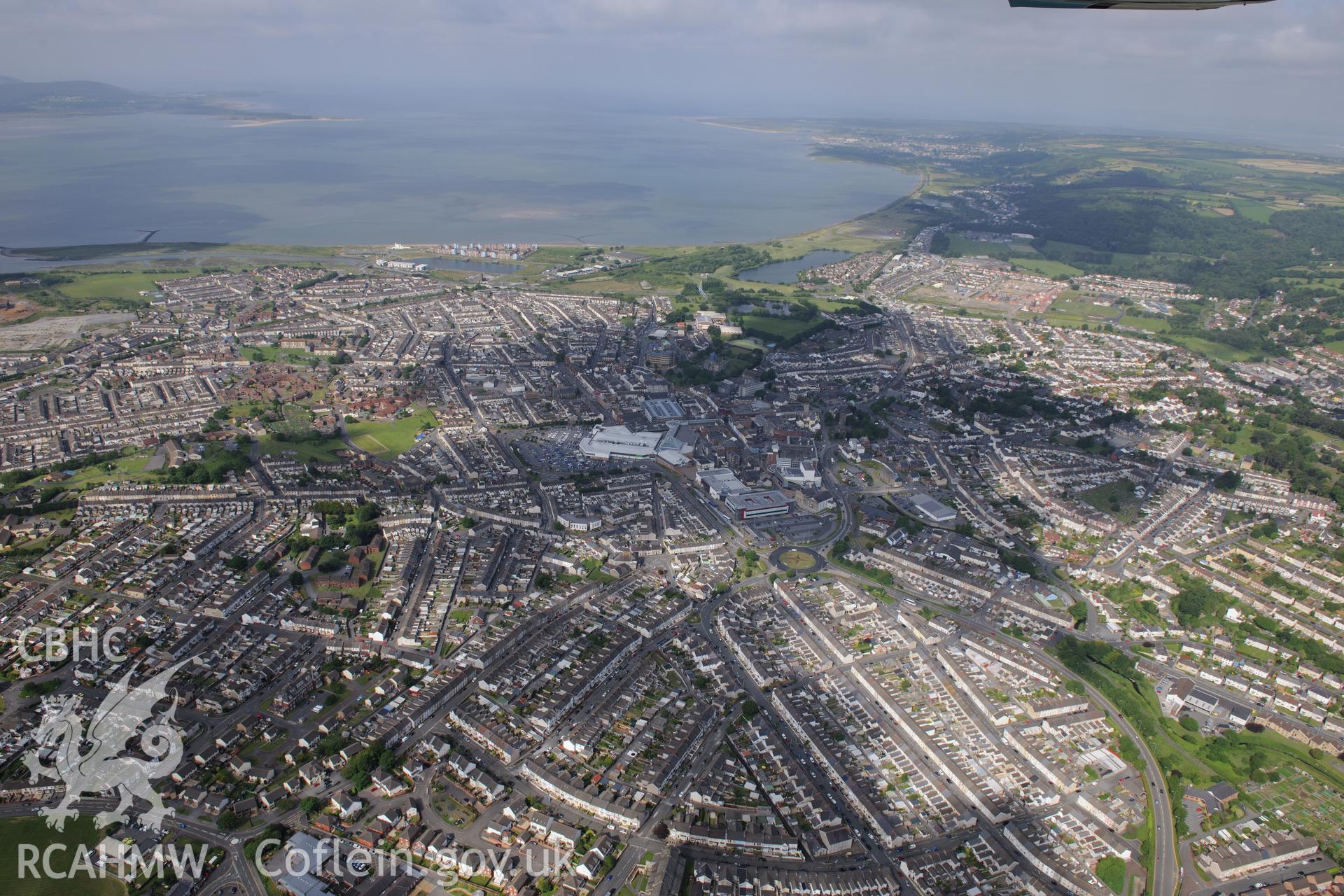 Landscape view of the town of Llanelli including the north dock and St. Elli's shopping centre, Llanelli. Oblique aerial photograph taken during the Royal Commission's programme of archaeological aerial reconnaissance by Toby Driver on 19th June 2015.