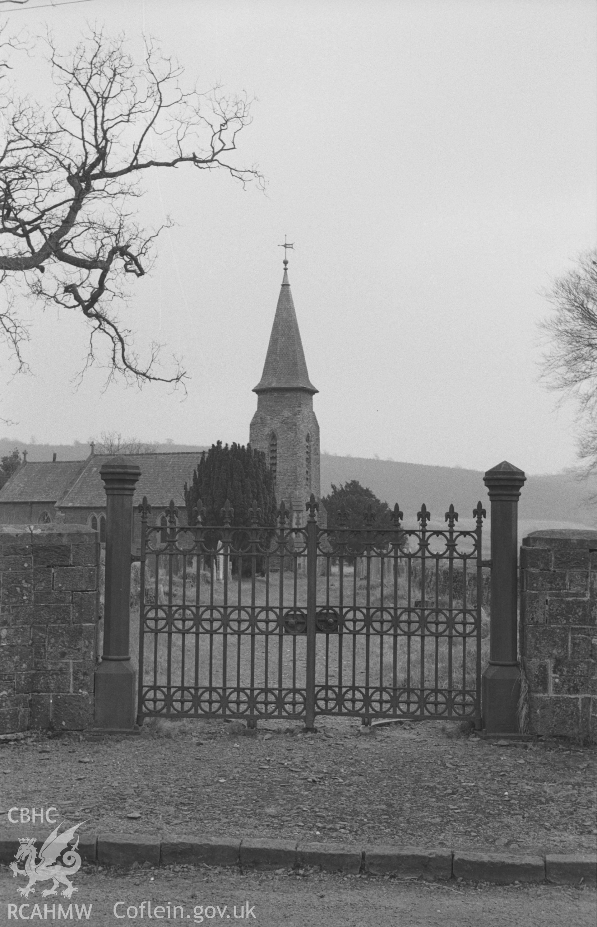 Digital copy of a black and white negative showing view of cast iron gates to churchyard at St. Bledrws' Church, Betws Bledrws. Photographed in March 1964 by Arthur O. Chater from Grid Reference SN 5955 5207, looking south south east.