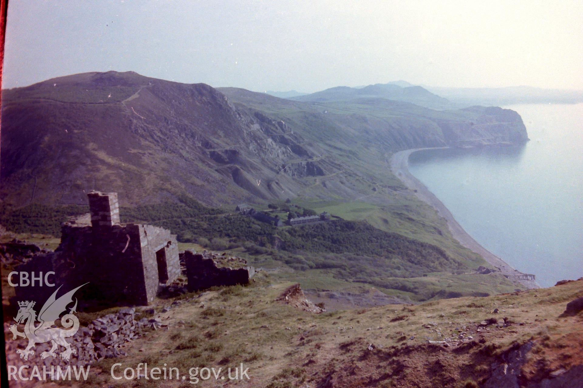 Digitised colour photograph of abandoned dwellings with Sea View and Mountain View Terraces at Porth-y-Nant beyond. Produced for dissertation: 'The Form & Architecture of 19th Century Industrial Settlements in Rural Wales' by Martin Davies, 1979.