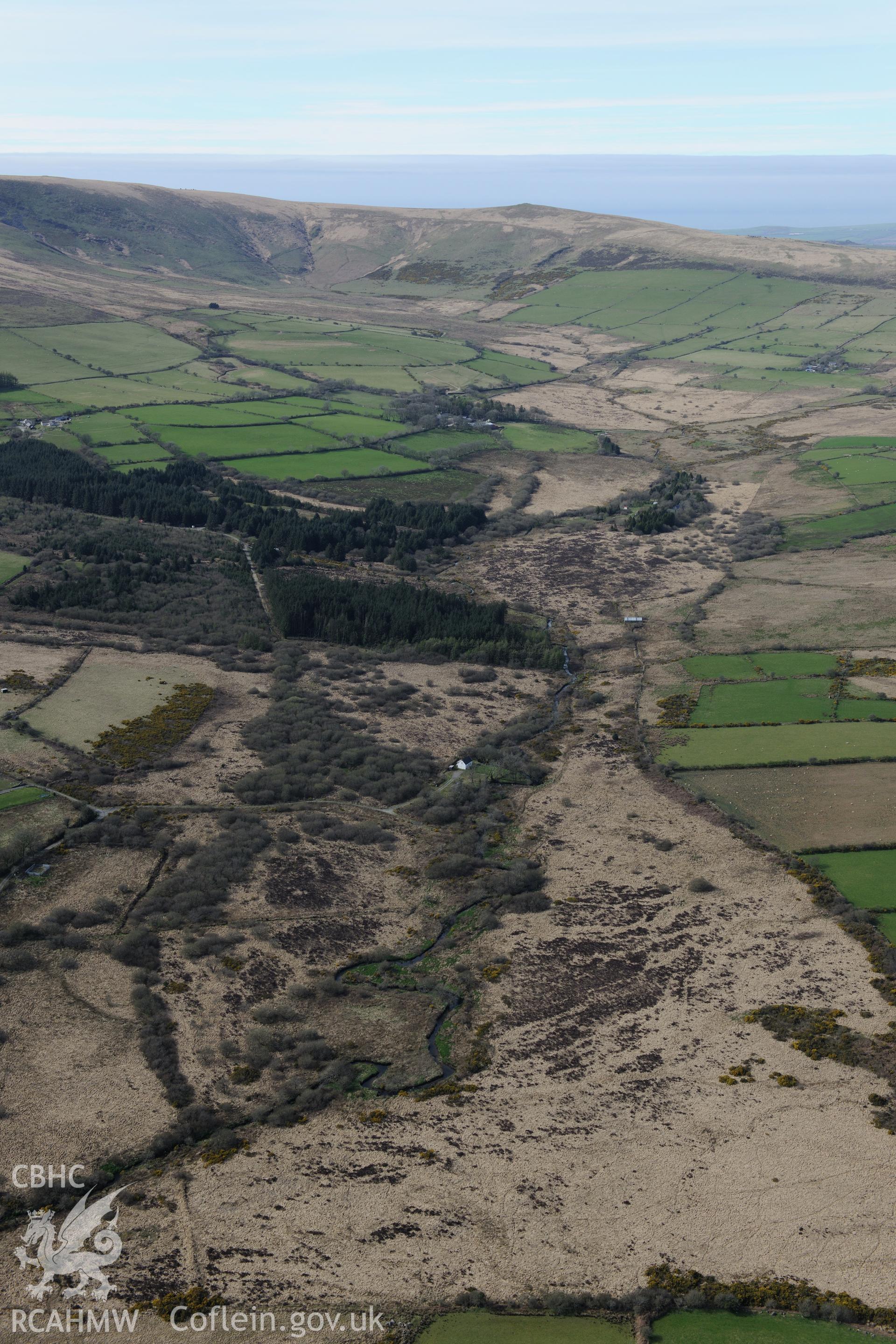 Distant landscape view of Foel feddau from the south-east. Oblique aerial photograph taken during the Royal Commission's programme of archaeological aerial reconnaissance by Toby Driver on 15th April 2015.