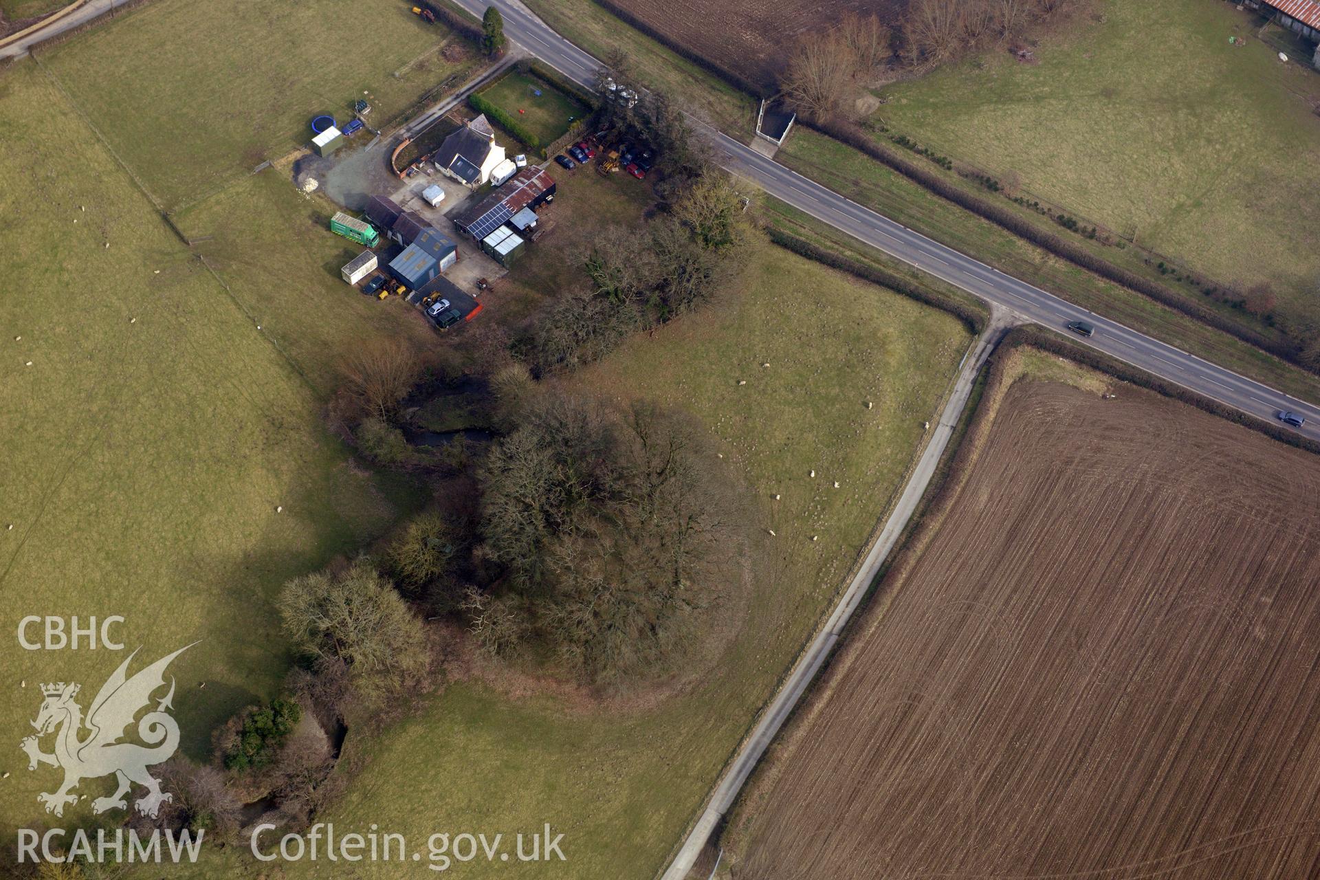 Upper Luggy motte and bailey castle, north east of Berriew. Oblique aerial photograph taken during the Royal Commission?s programme of archaeological aerial reconnaissance by Toby Driver on 28th February 2013.